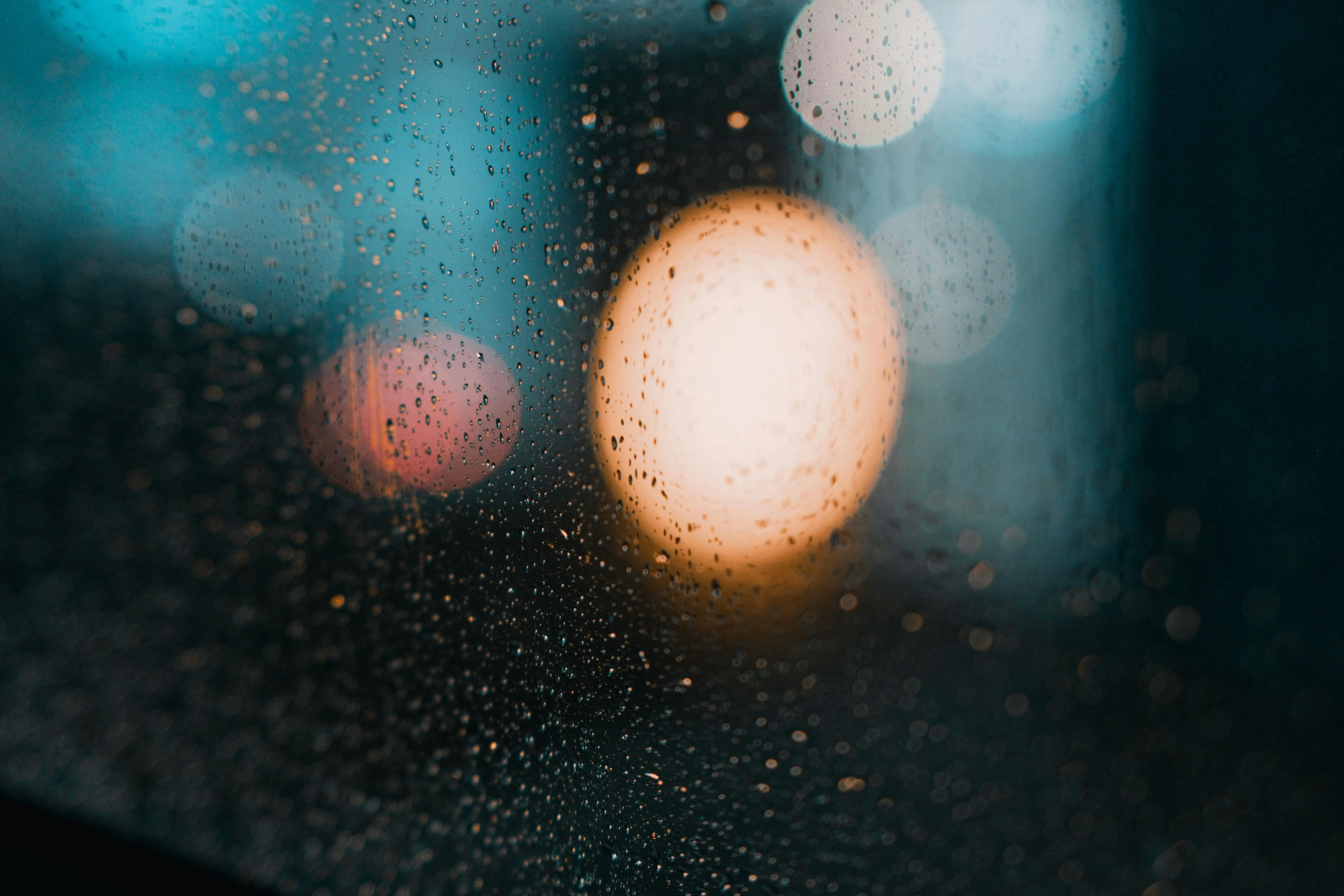 Rain Smeared Lights Reflected in Water at Night Wallpaper