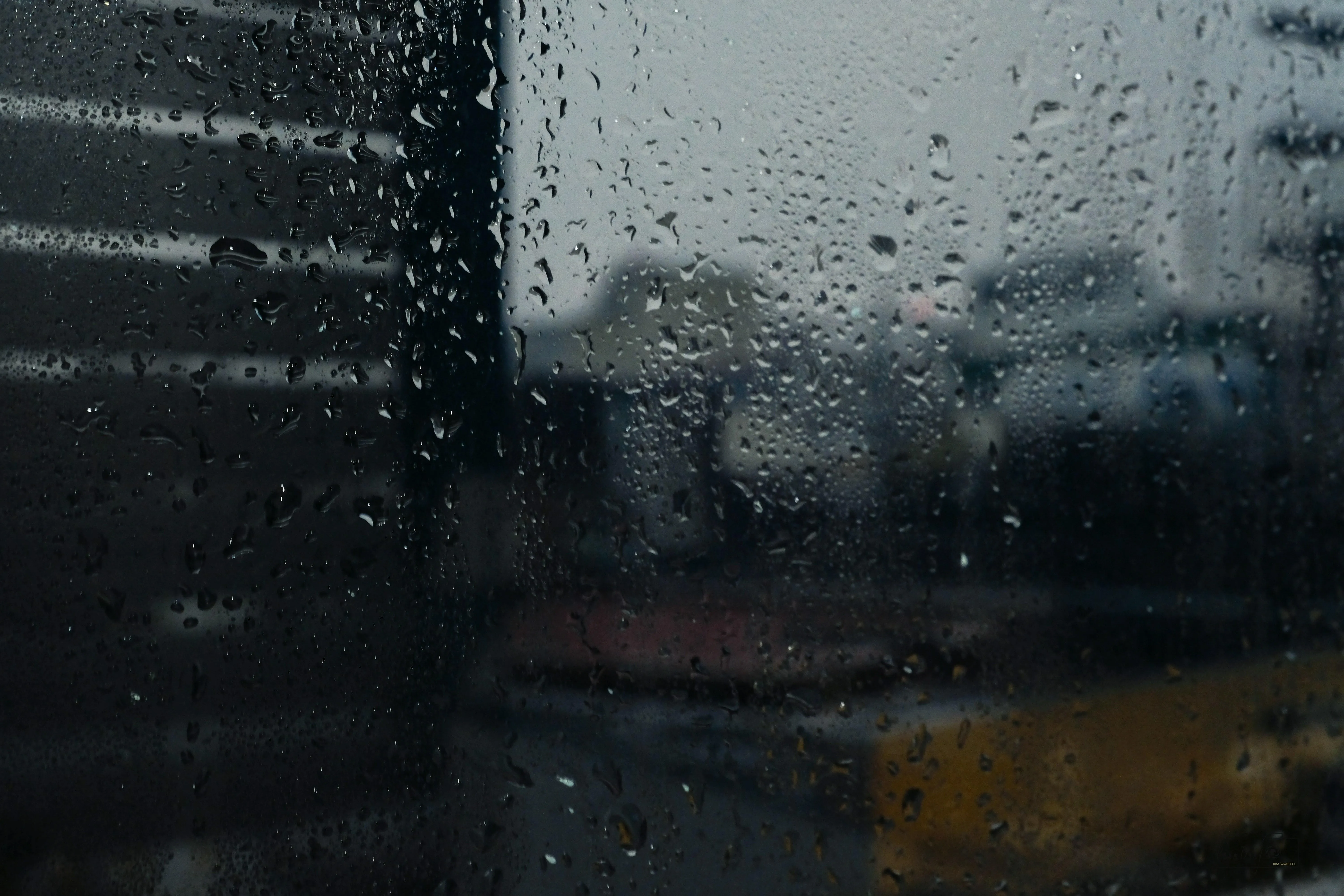 Rain Streaks on Windshield Overlooking City Road