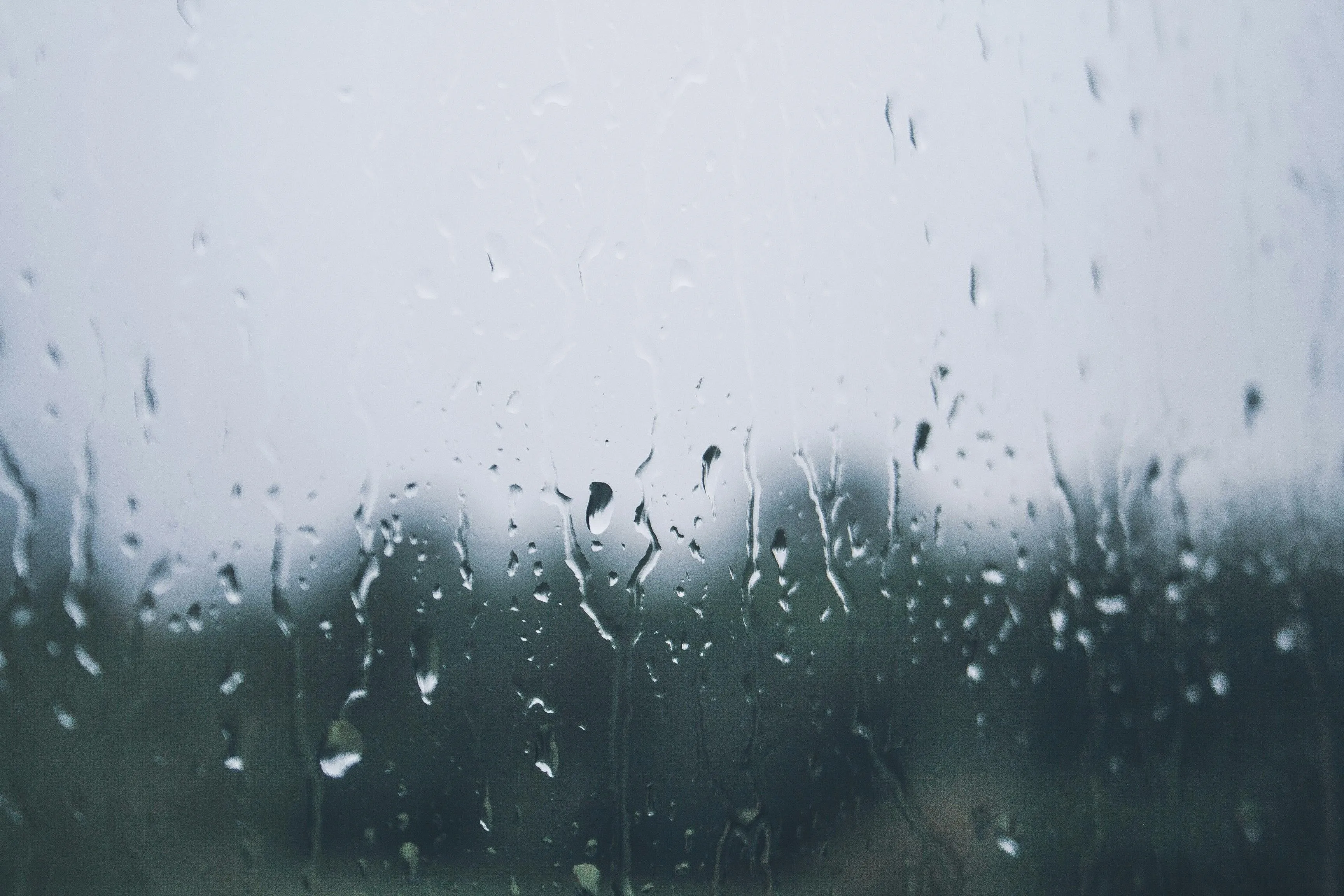 Raindrops on Glass Window with Blurred Background