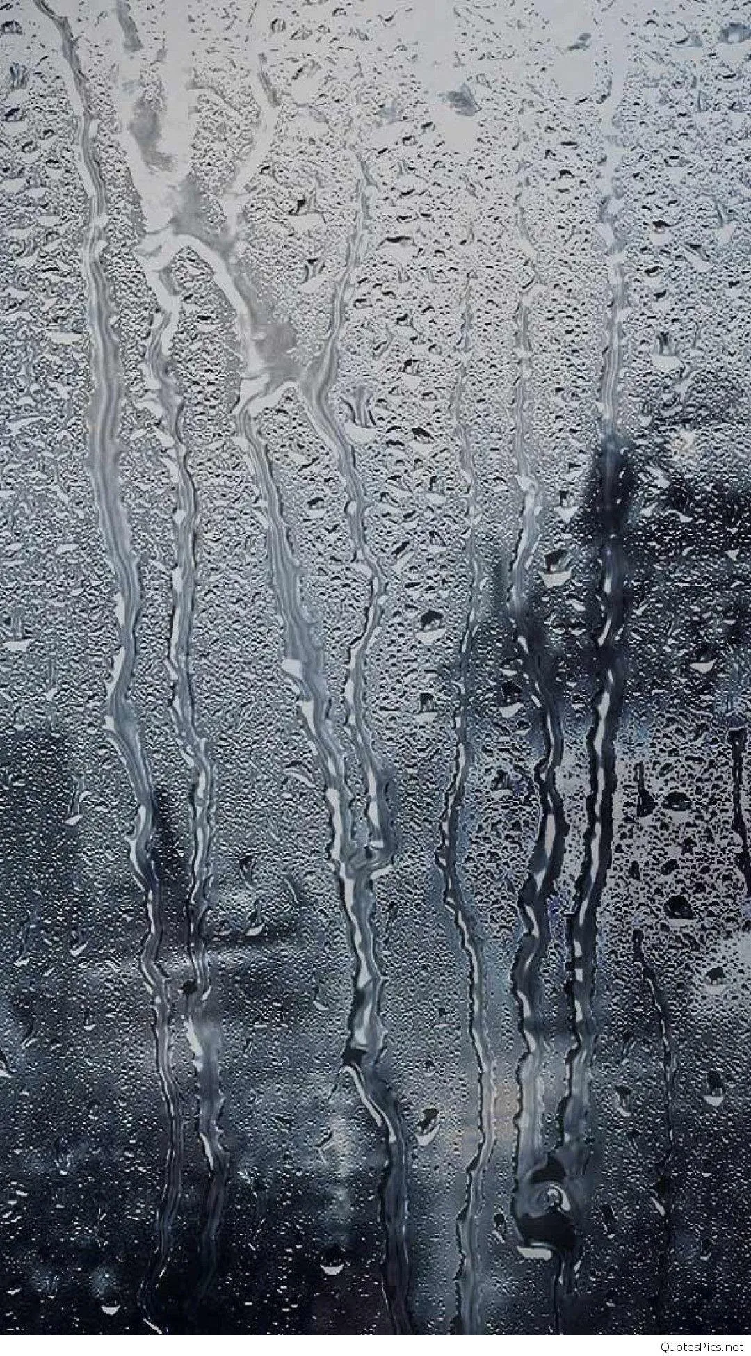 Raindrops on Glass Window with Blurred Outdoor Scenery