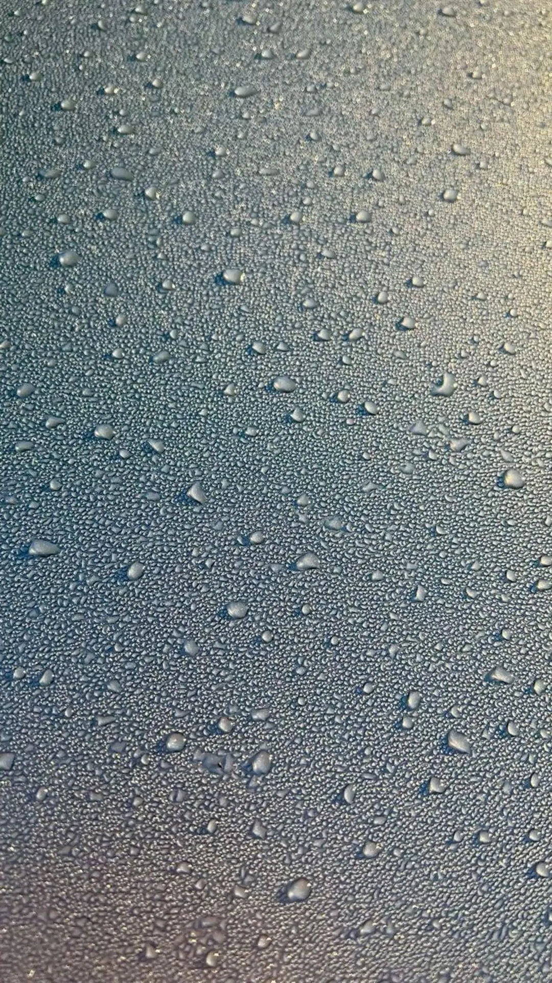 Raindrops on Window Glass Blurring View of Buildings