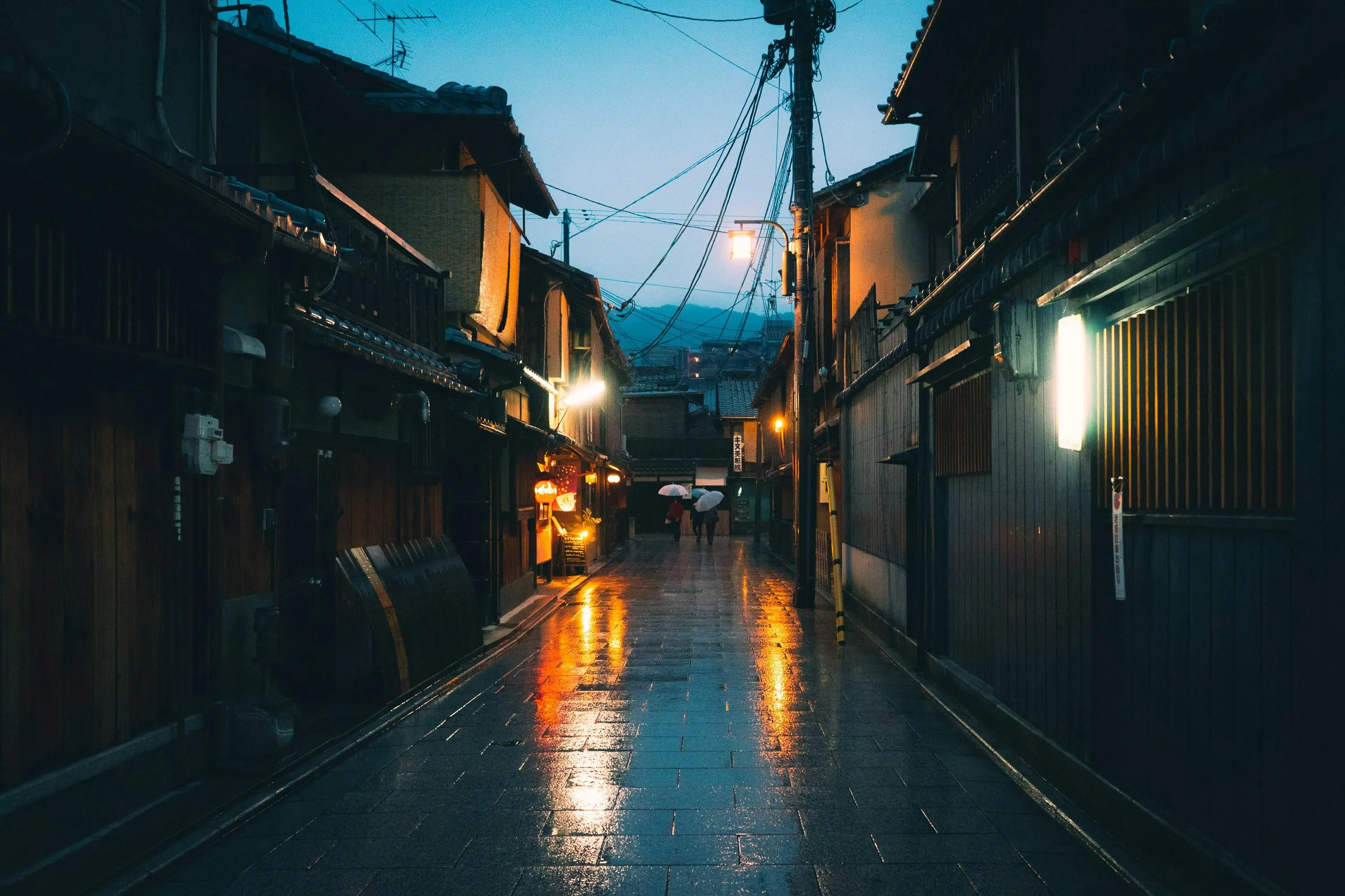 Rainy Narrow Street in Old Town with Lights Wallpaper