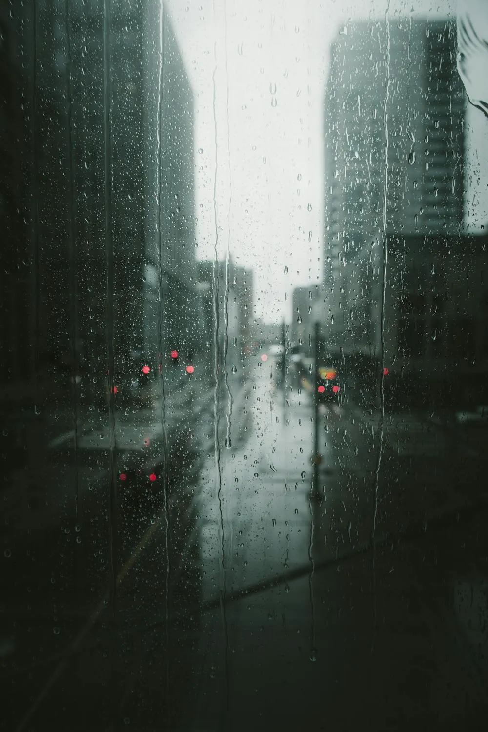 Rainy Urban Scene with Wet Streets and Cloudy Sky Image