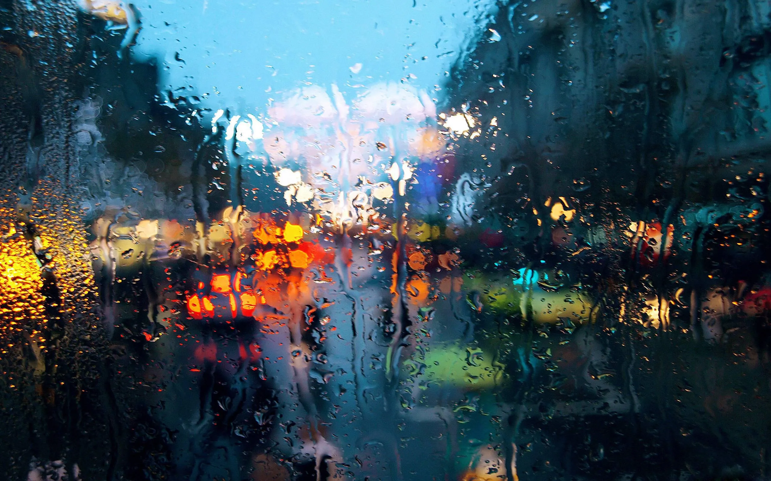 Rainy Urban Street with Blurred Colorful Lights at Night