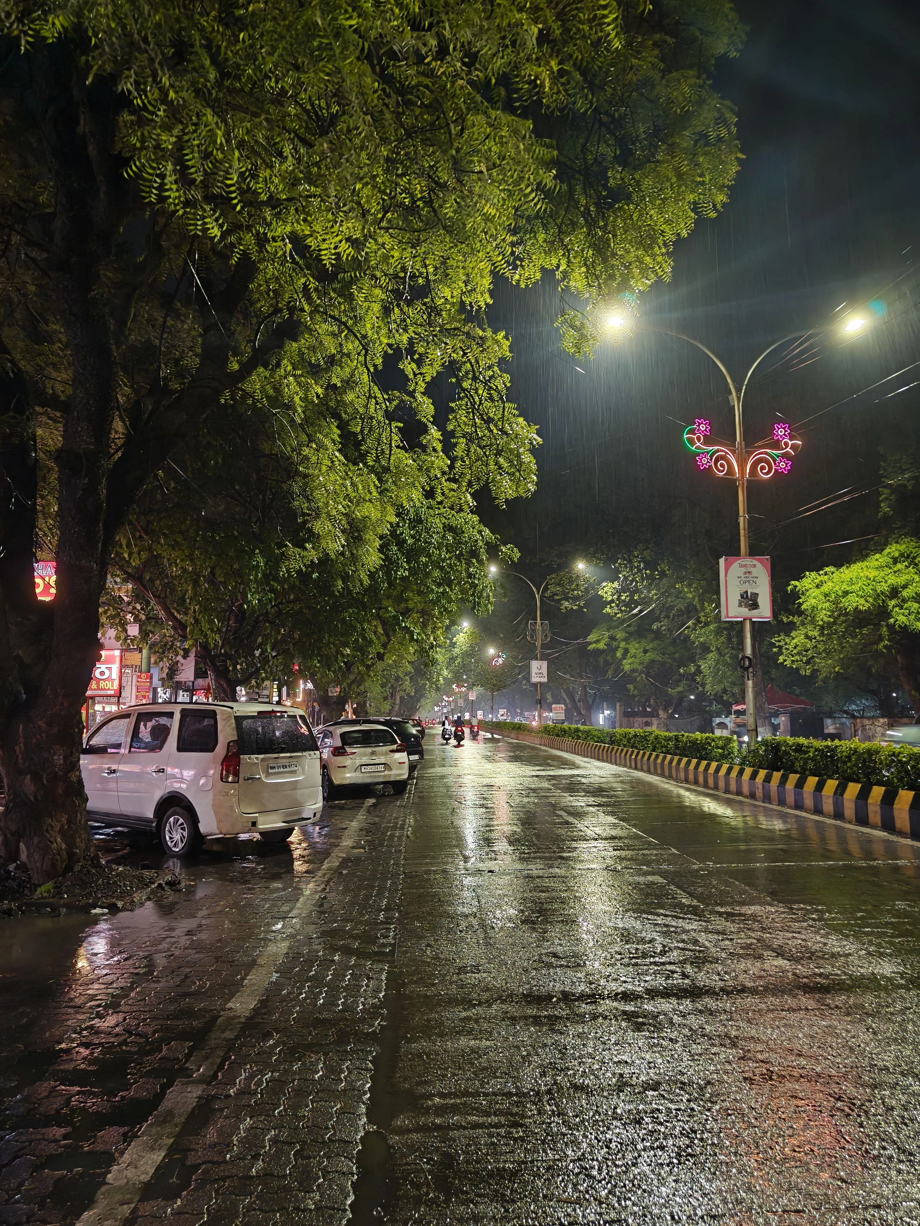 Reflections of City Lights on Wet Night Pavement Image