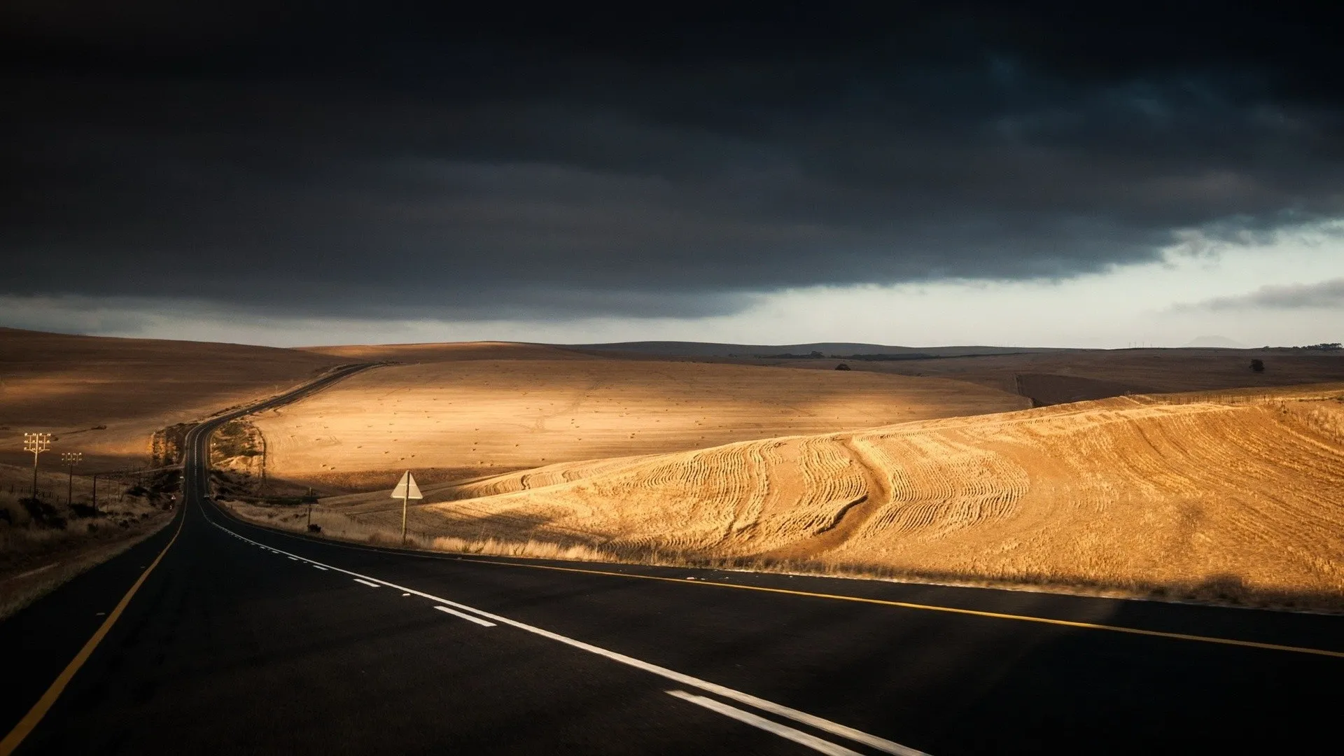 Road Leading To Desert Under Dramatic Cloudy Sky HD Image