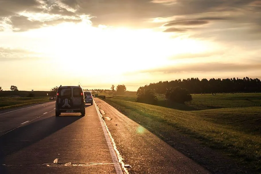 Road Trip Under Sunset Skies with Rolling Cloud Horizon
