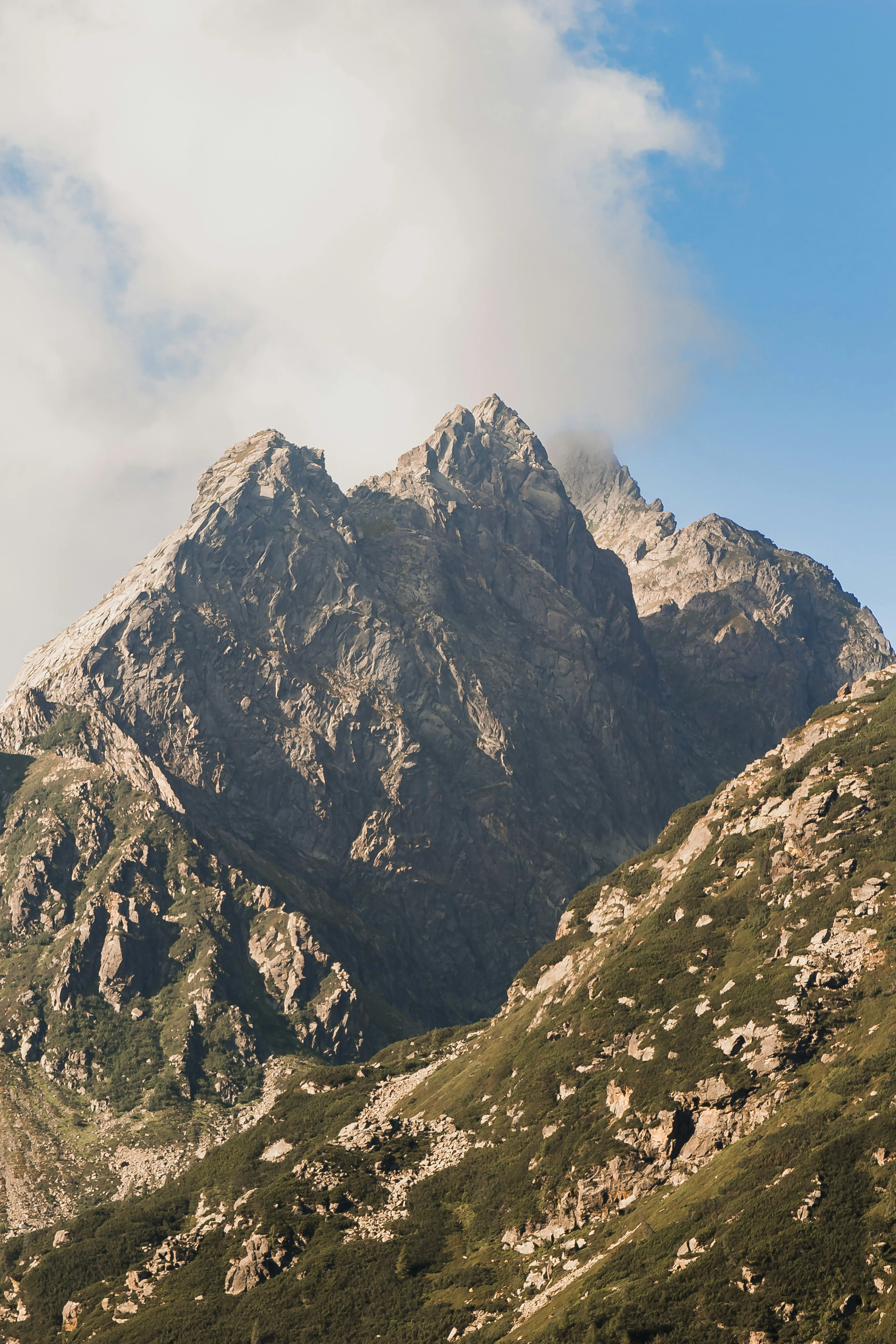 Rocky Mountain Peaks Beneath a Bright Blue Cloudy Sky