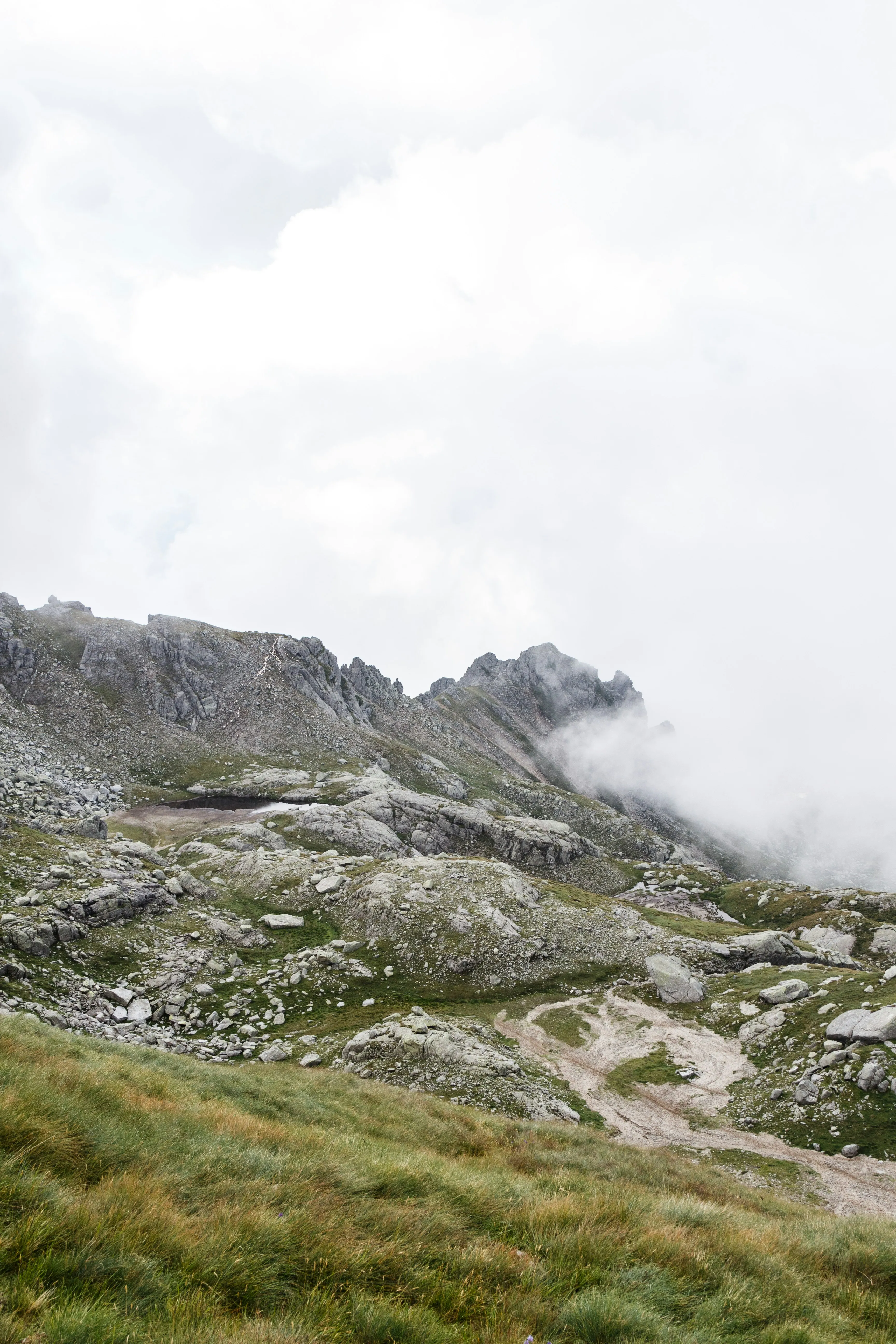 Rocky Mountain with White Clouds and Misty Atmosphere
