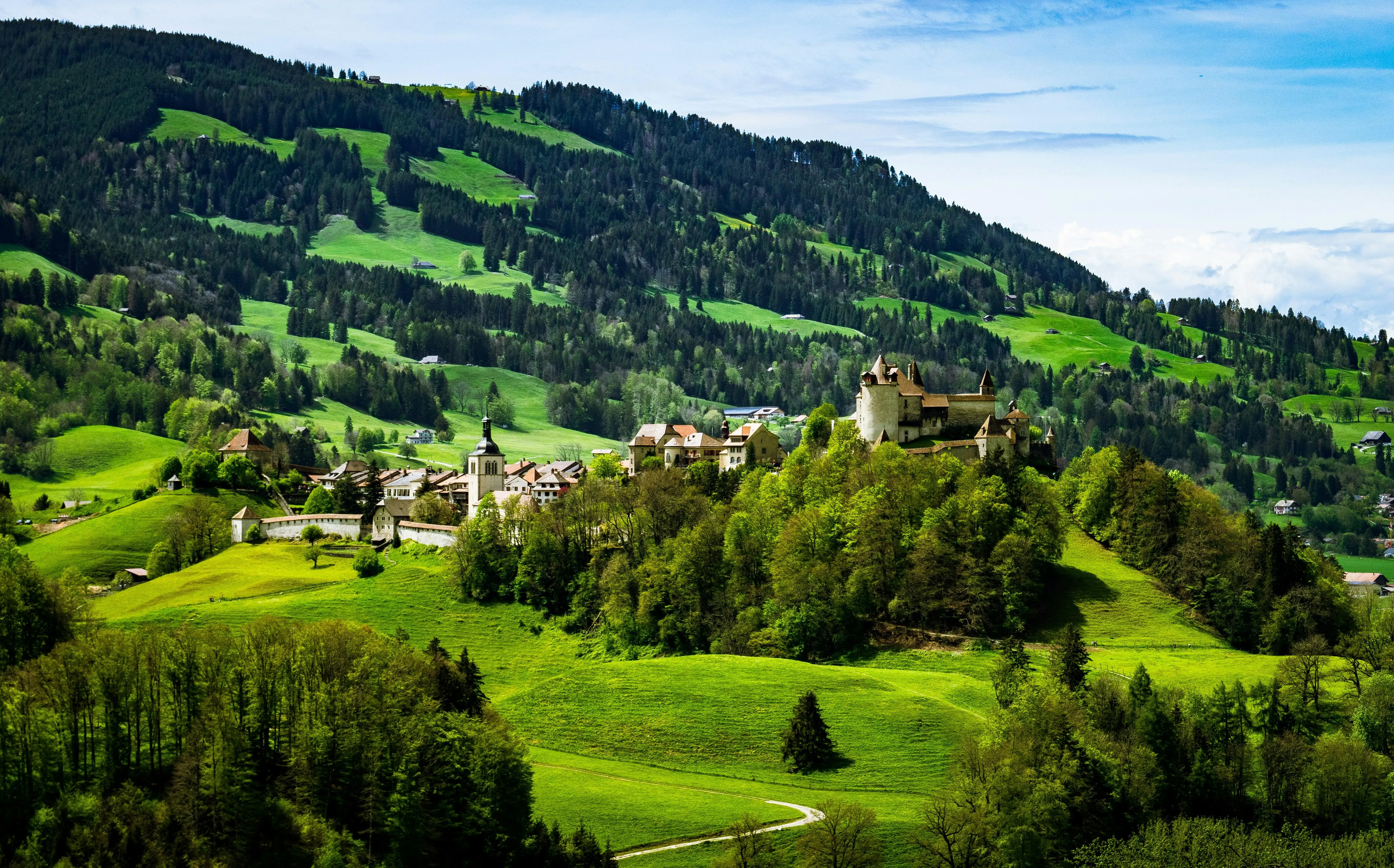 Rolling green hills under a bright summer sky image