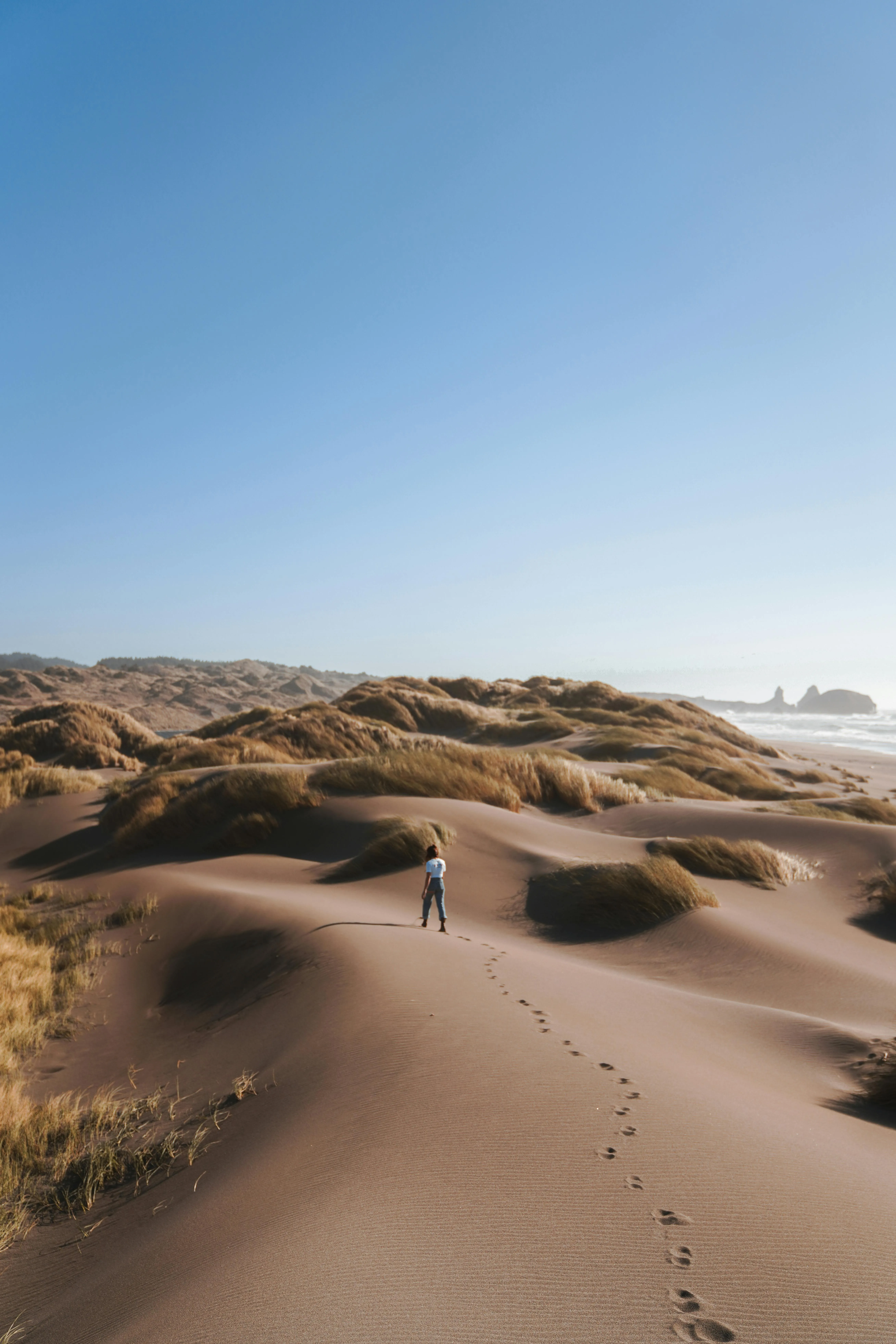 Sandy Desert Dunes Under Clear Sky with Few Clouds Image