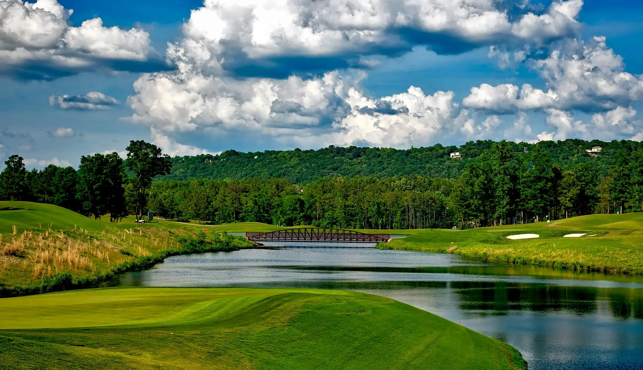 Scenic Golf Course with Water Hazards Under a Cloudy Sky