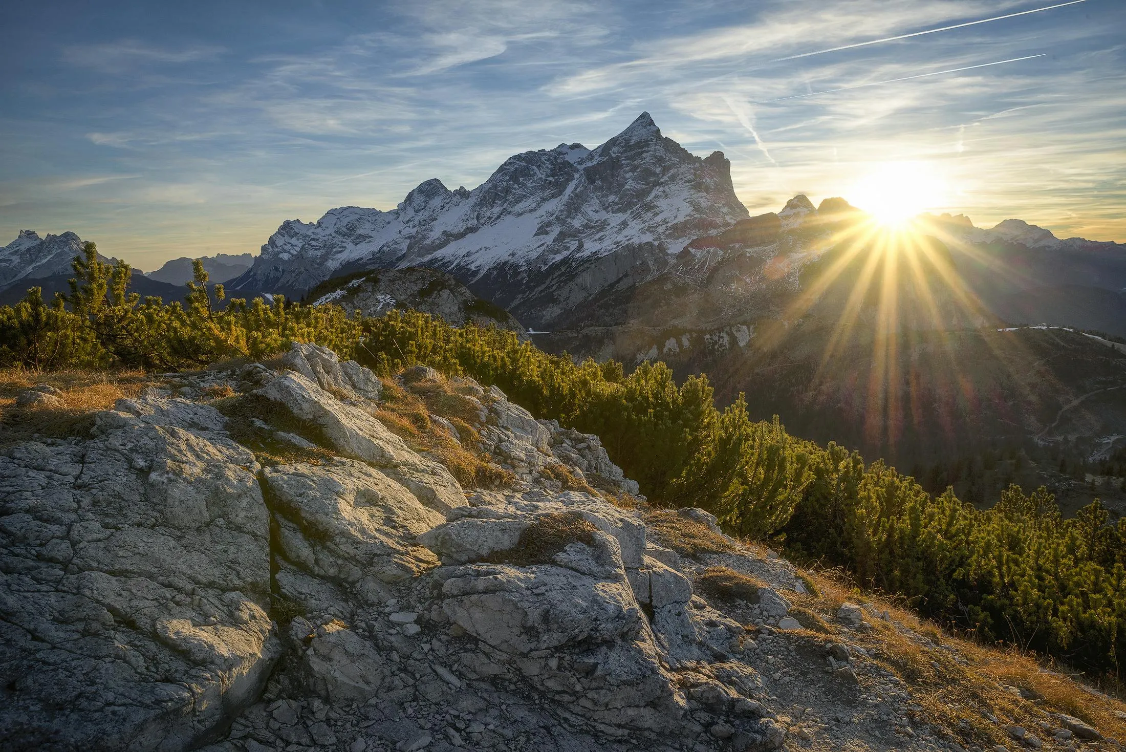 Scenic Mountain Peaks Lit by Sunrise with the Forest Below