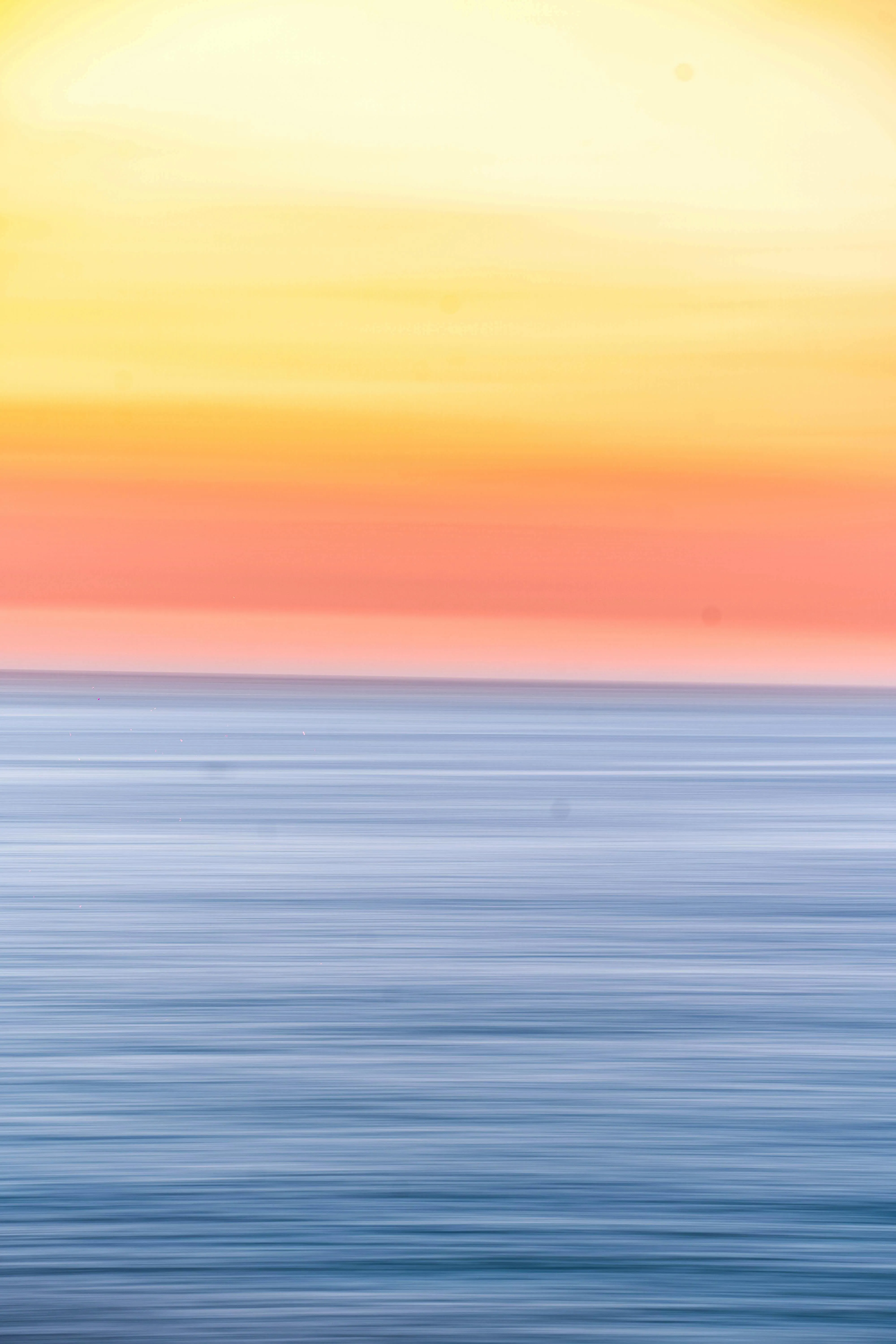 Serene Ocean Scene at Sunset with Gentle Clouds in the Sky