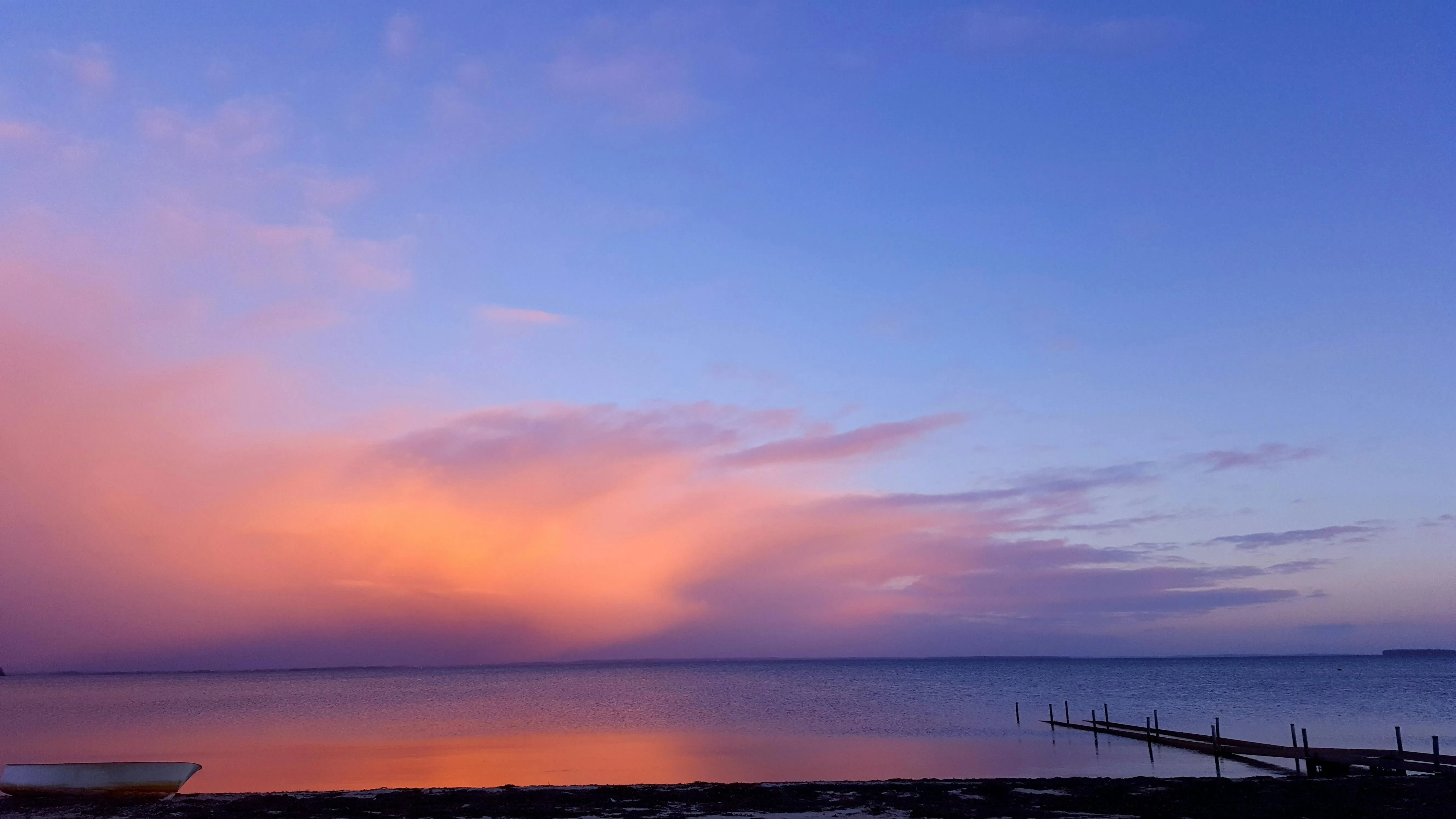 Serene Sunset with Pink and Purple Clouds Over Horizon