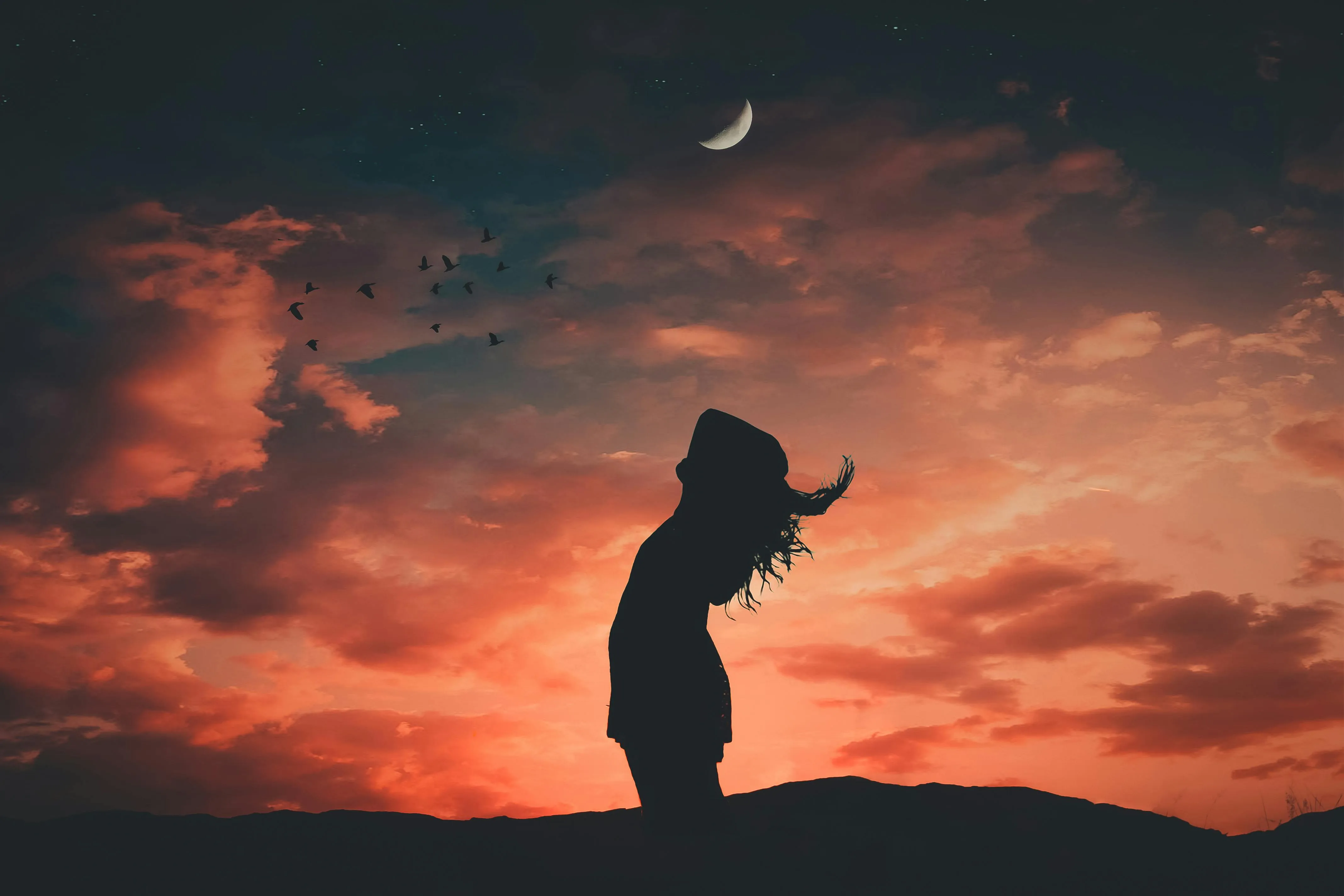 Silhouette of Child Reaching For Sky at Fiery Sunset Image