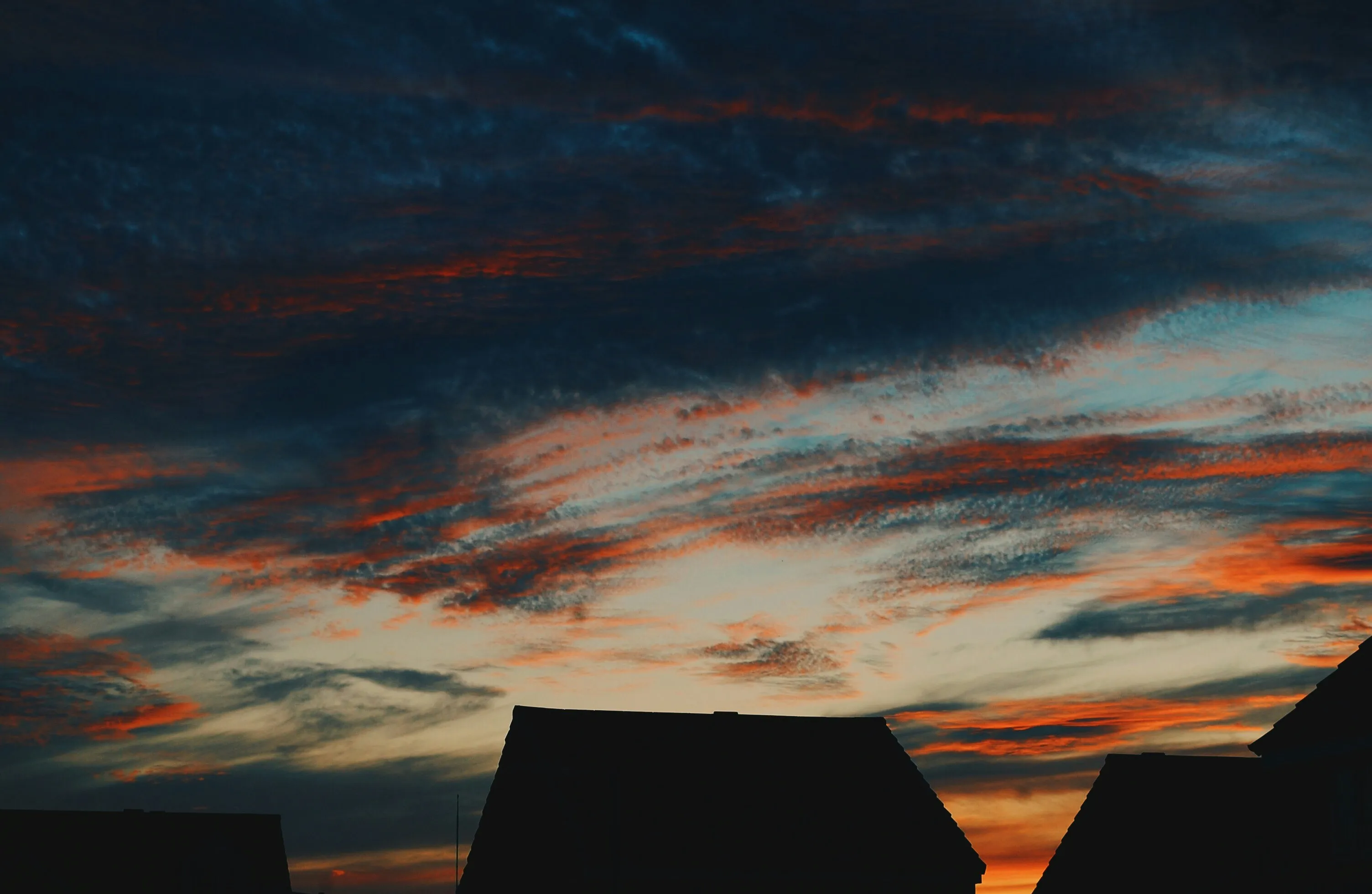 Silhouette of House Under a Colorful Sunset Sky Image