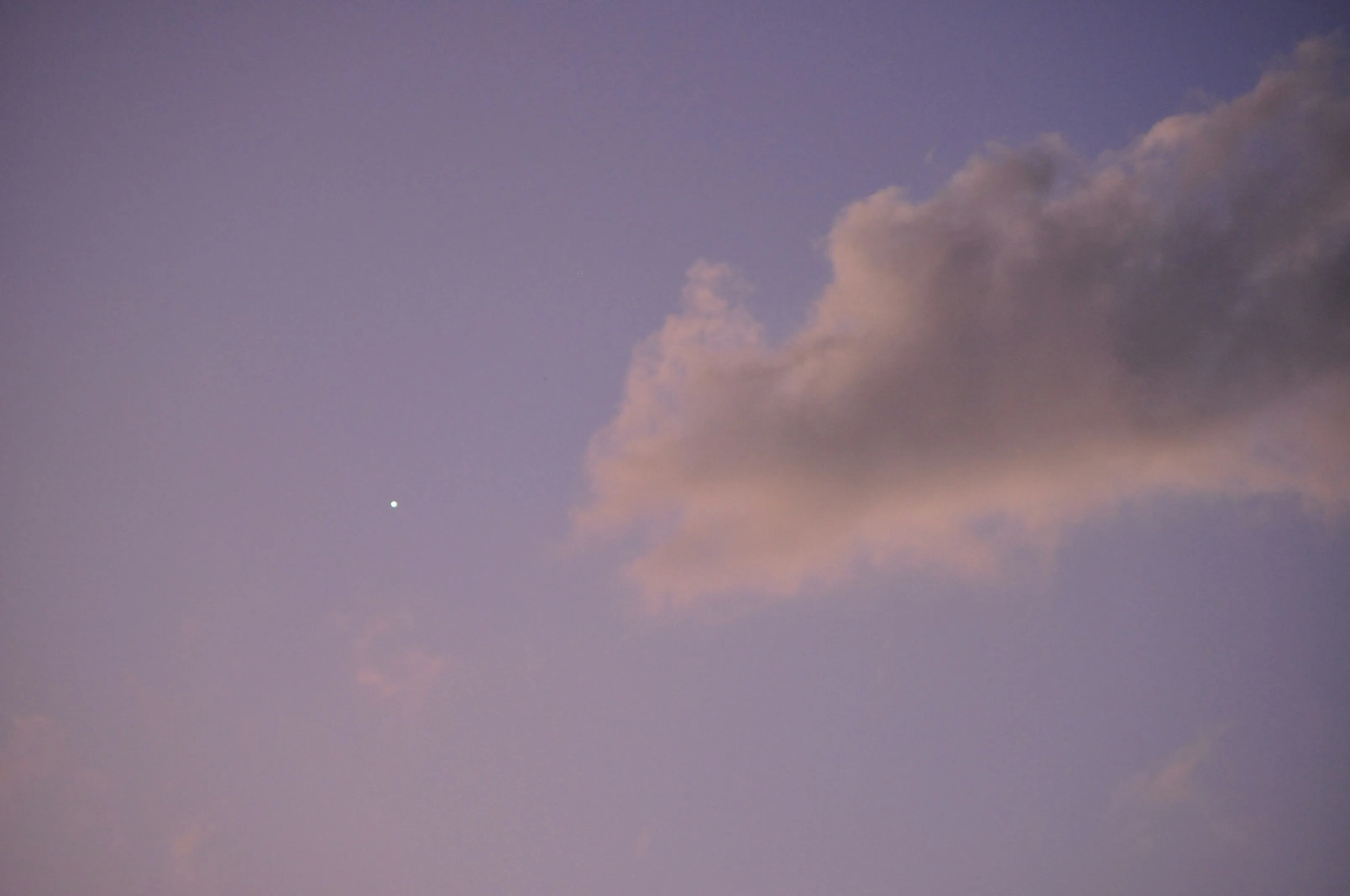 Single Pink Cloud Floating in a Purple Evening Sky Image