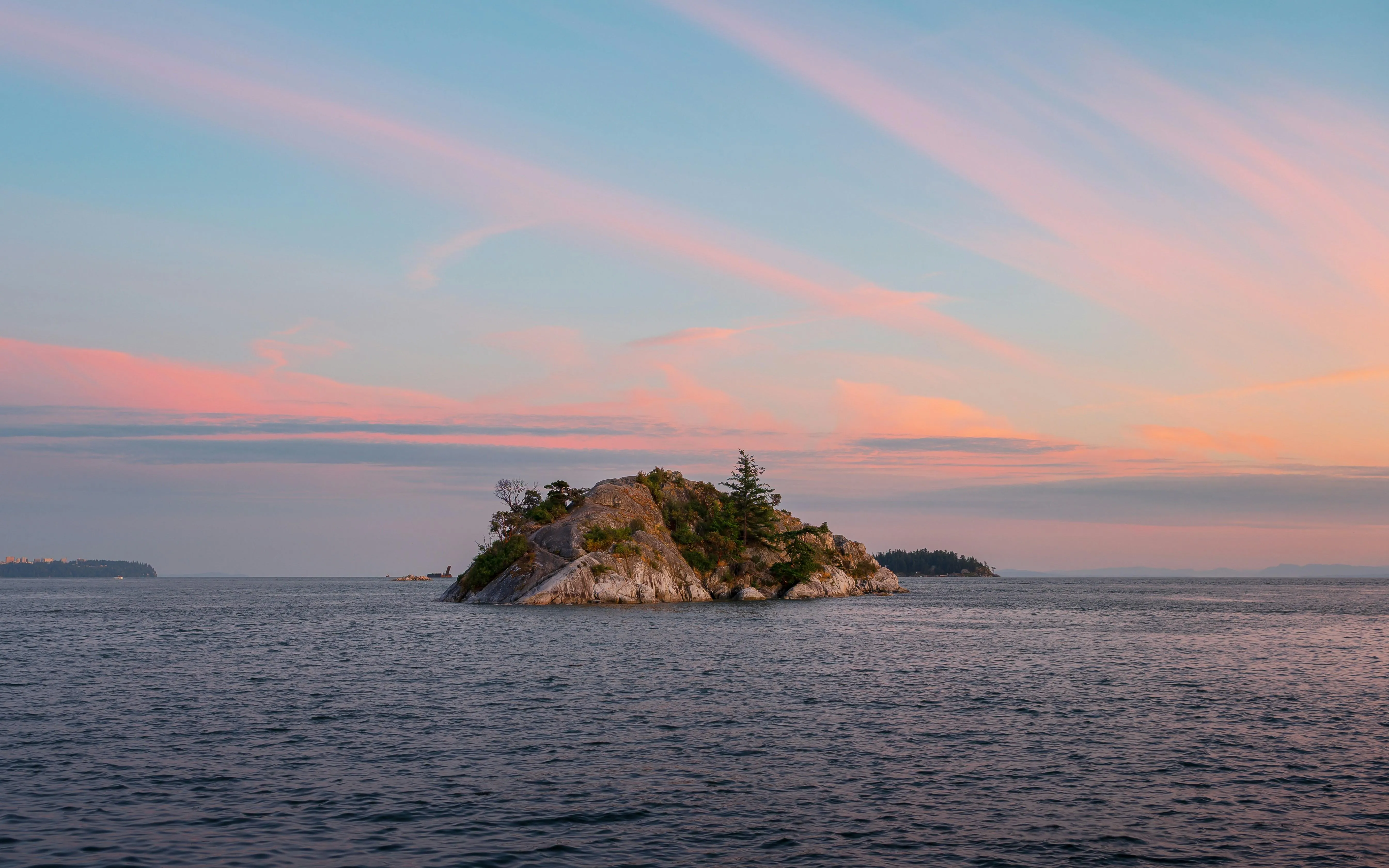 Small Rocky Island Surrounded by Clear Blue Ocean image