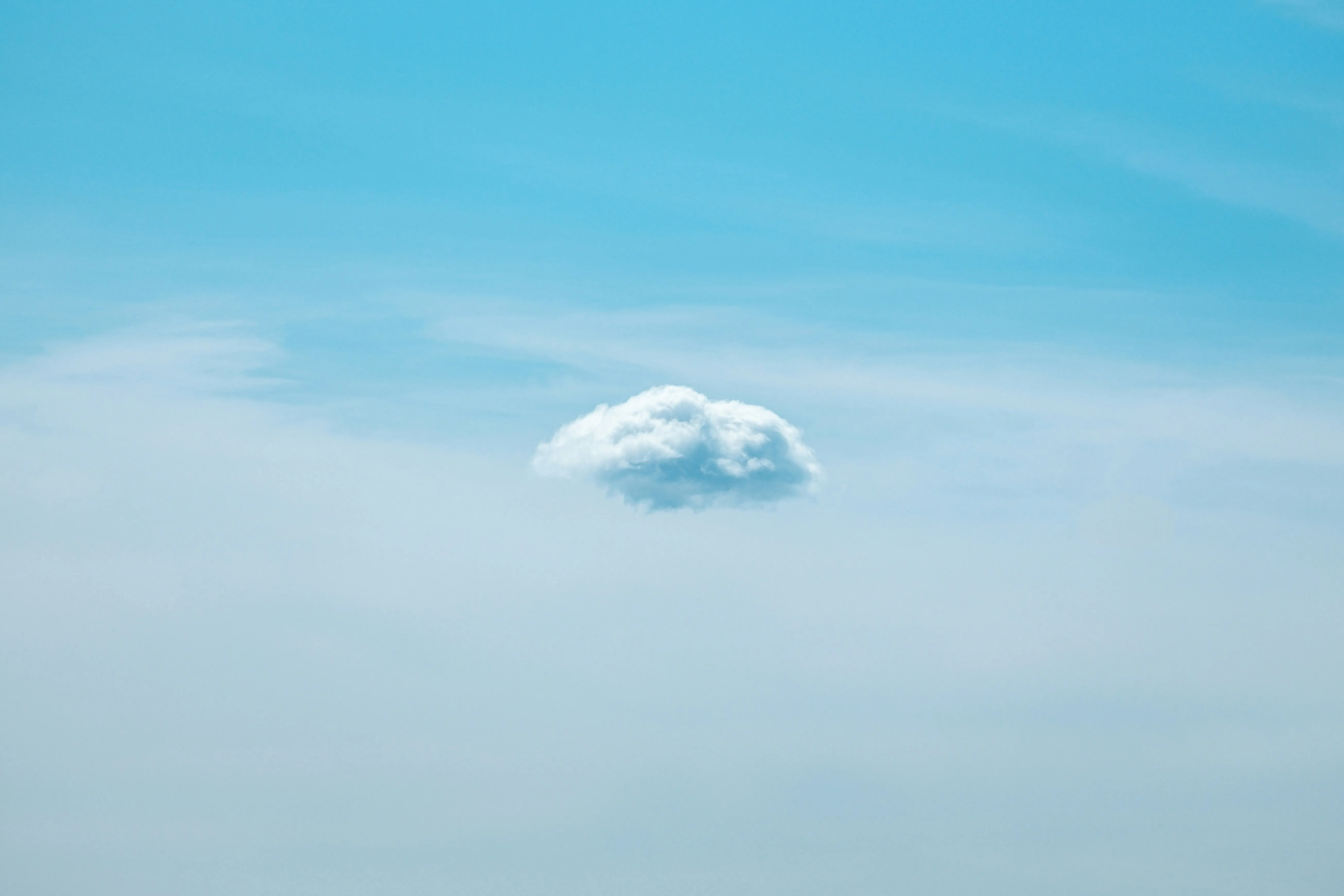 Small White Cloud Floating Alone in Bright Blue Sky