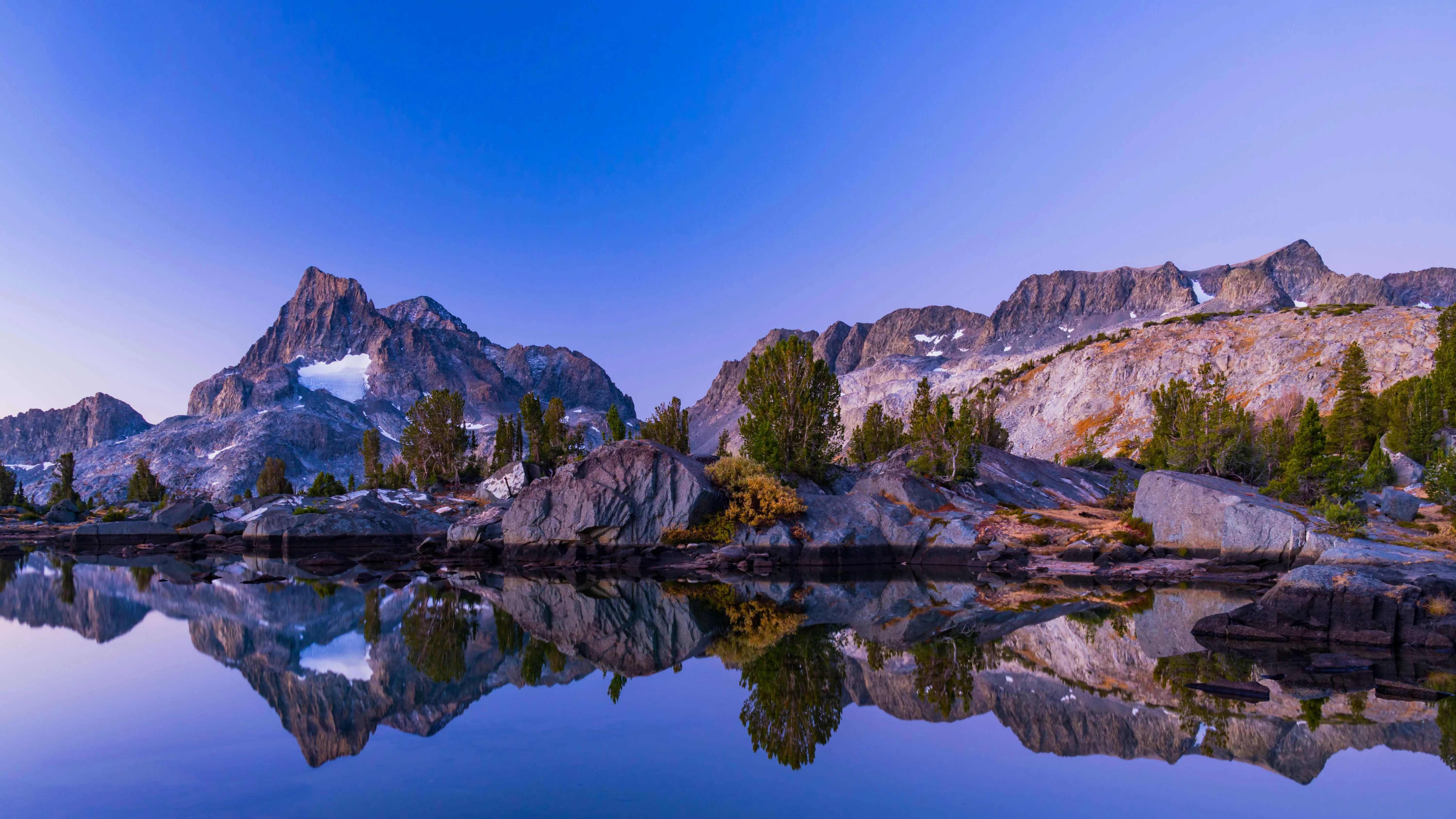 Snow capped mountain peaks under clear blue sky image