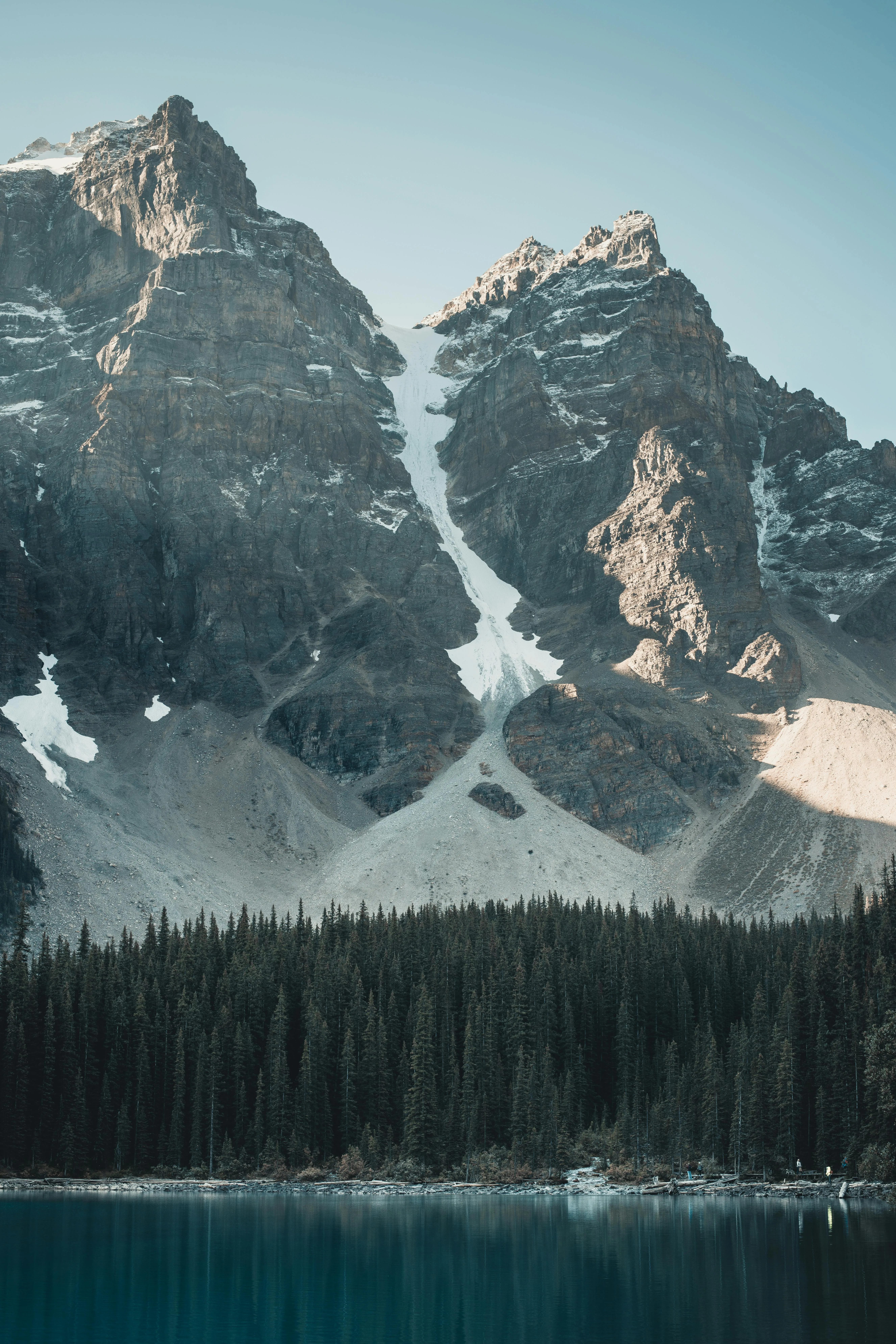 Snowy Mountain Peaks Towering Above a Pine Forest Valley