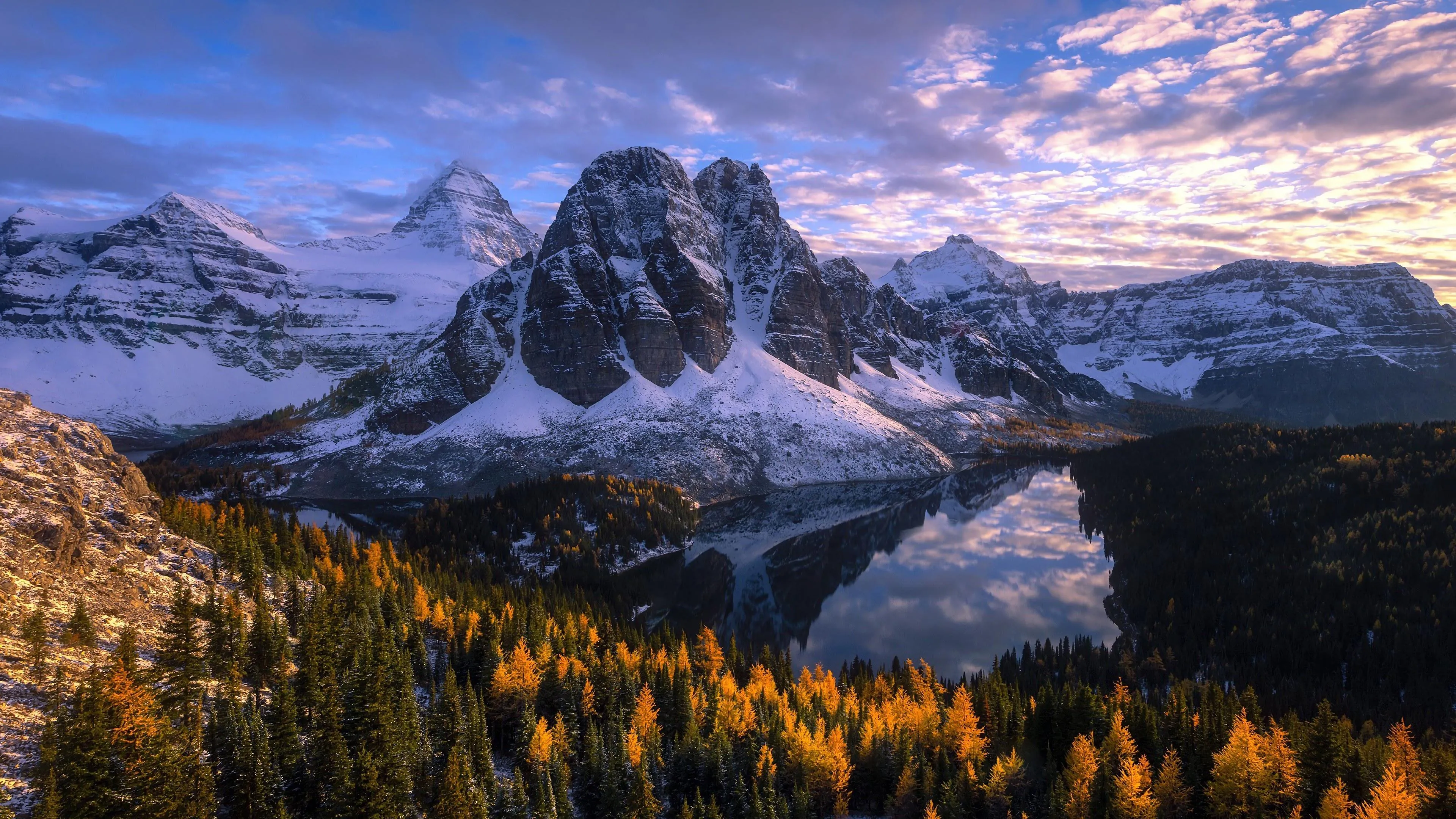 Snowy Mountain Peaks Under Colorful Sunset Sky Wallpaper