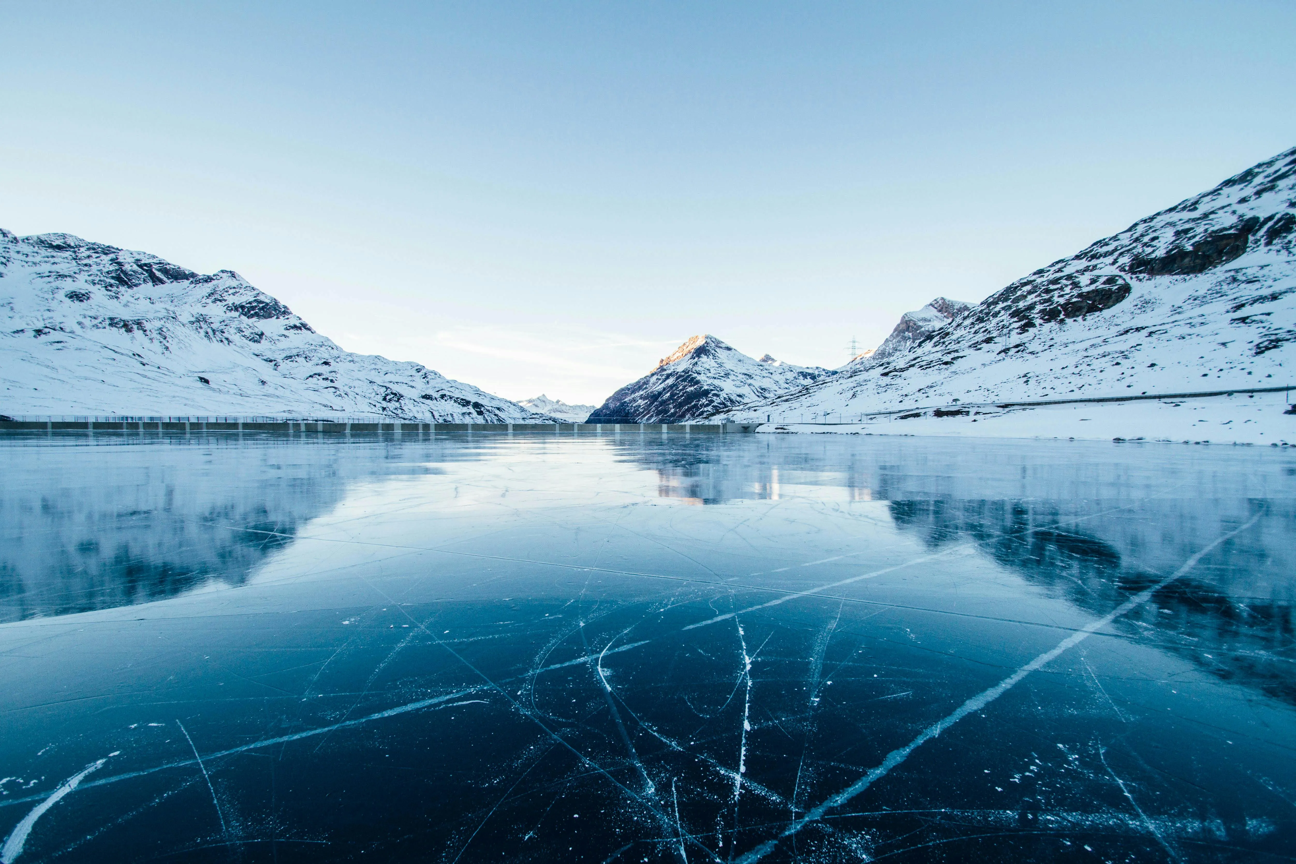 Snowy Mountains Reflecting in Crystal Clear Blue Lake