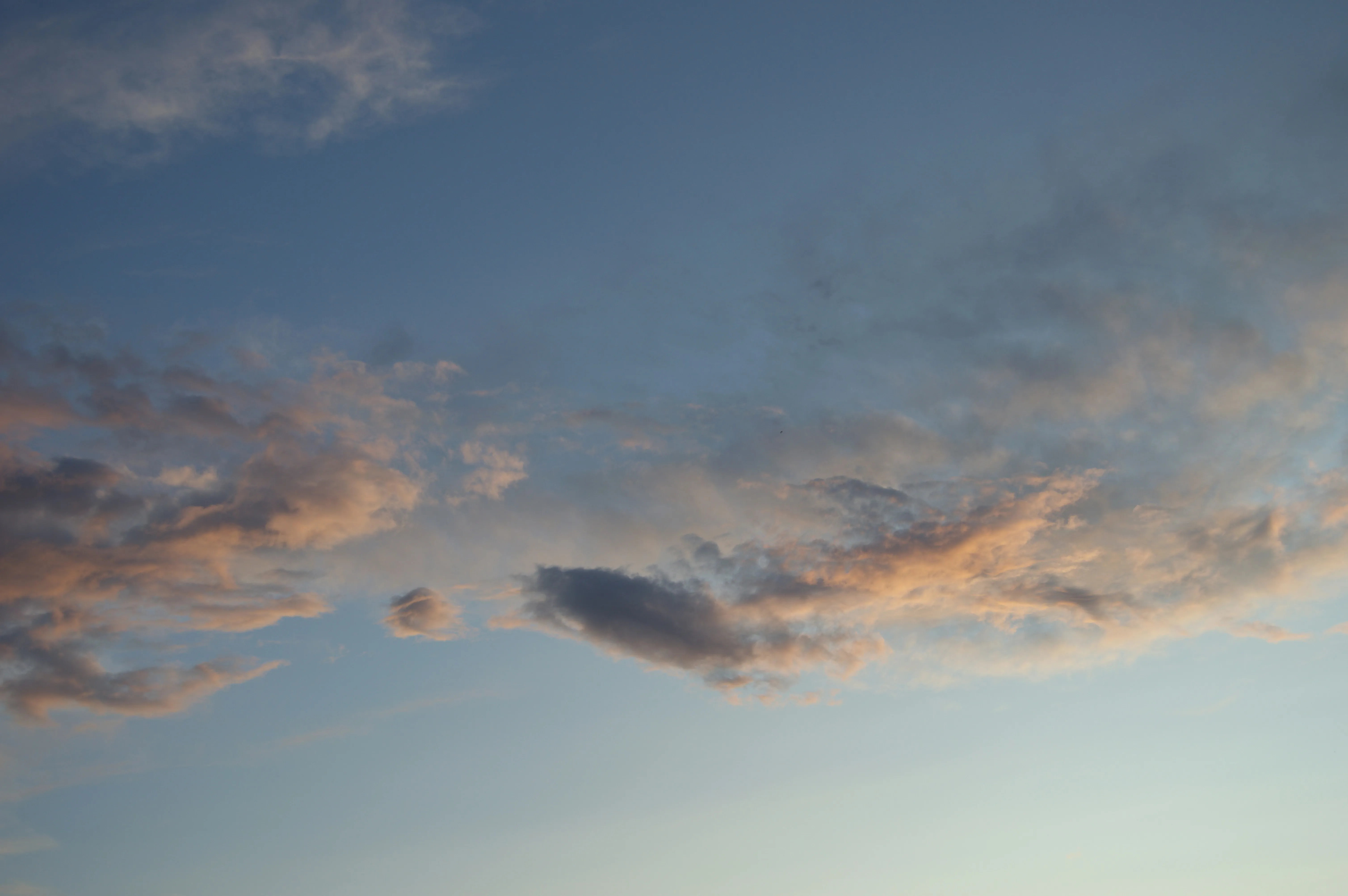 Soft Clouds Drifting in a Muted Early Morning Sky Wallpaper