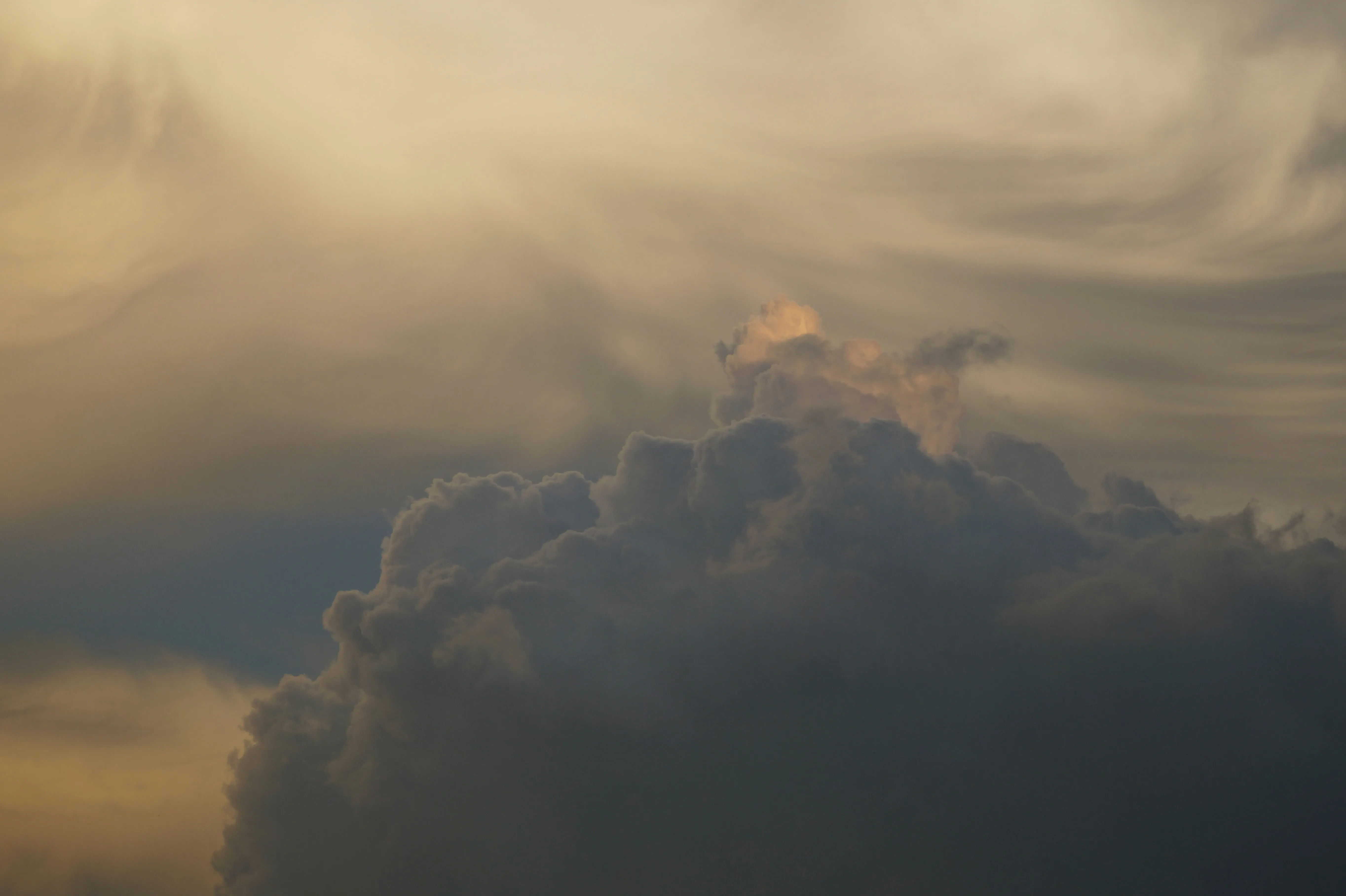Soft Golden Clouds Forming Over Calm Evening Horizon