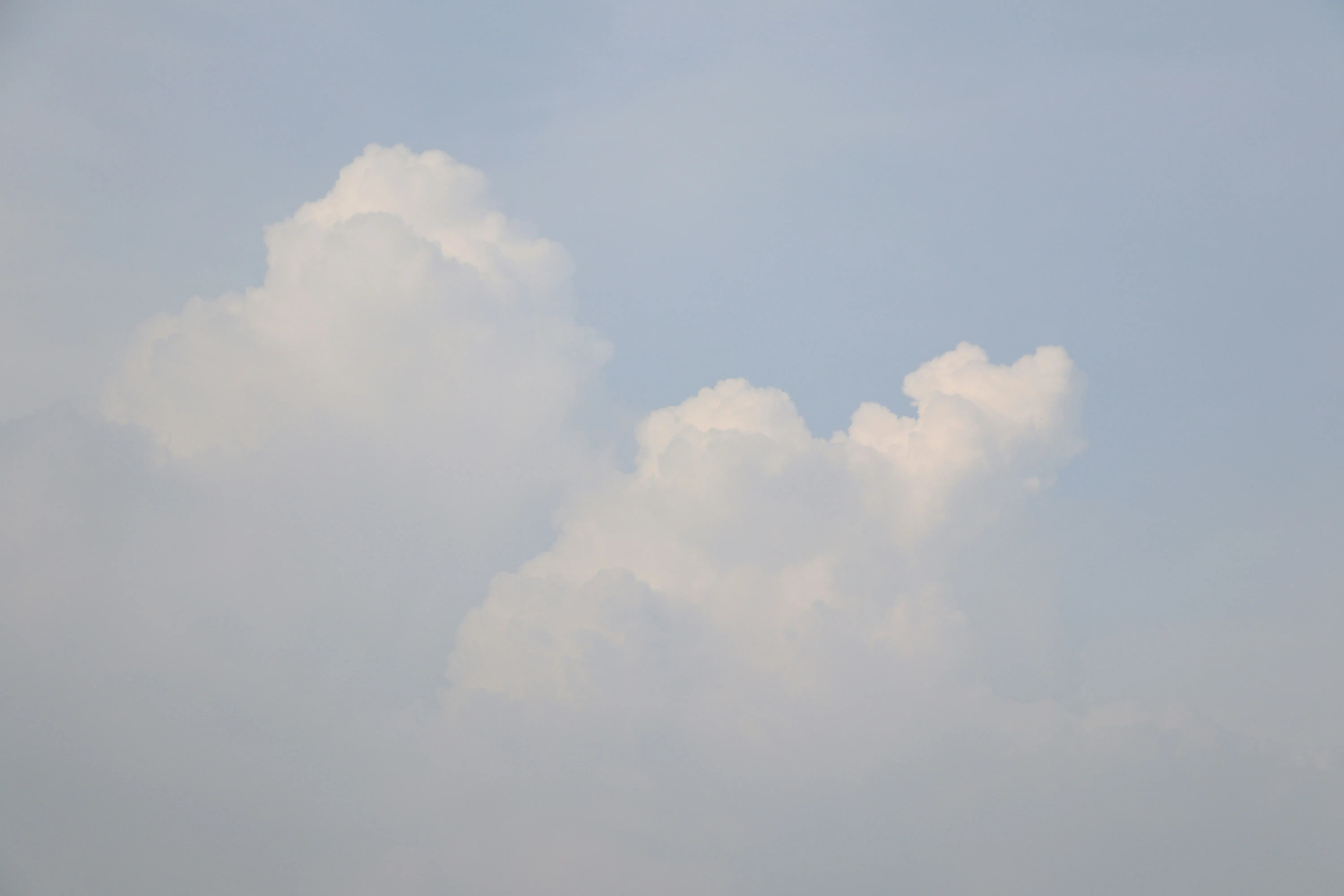 Soft Gray Clouds Drifting Across Pale Blue Morning Image