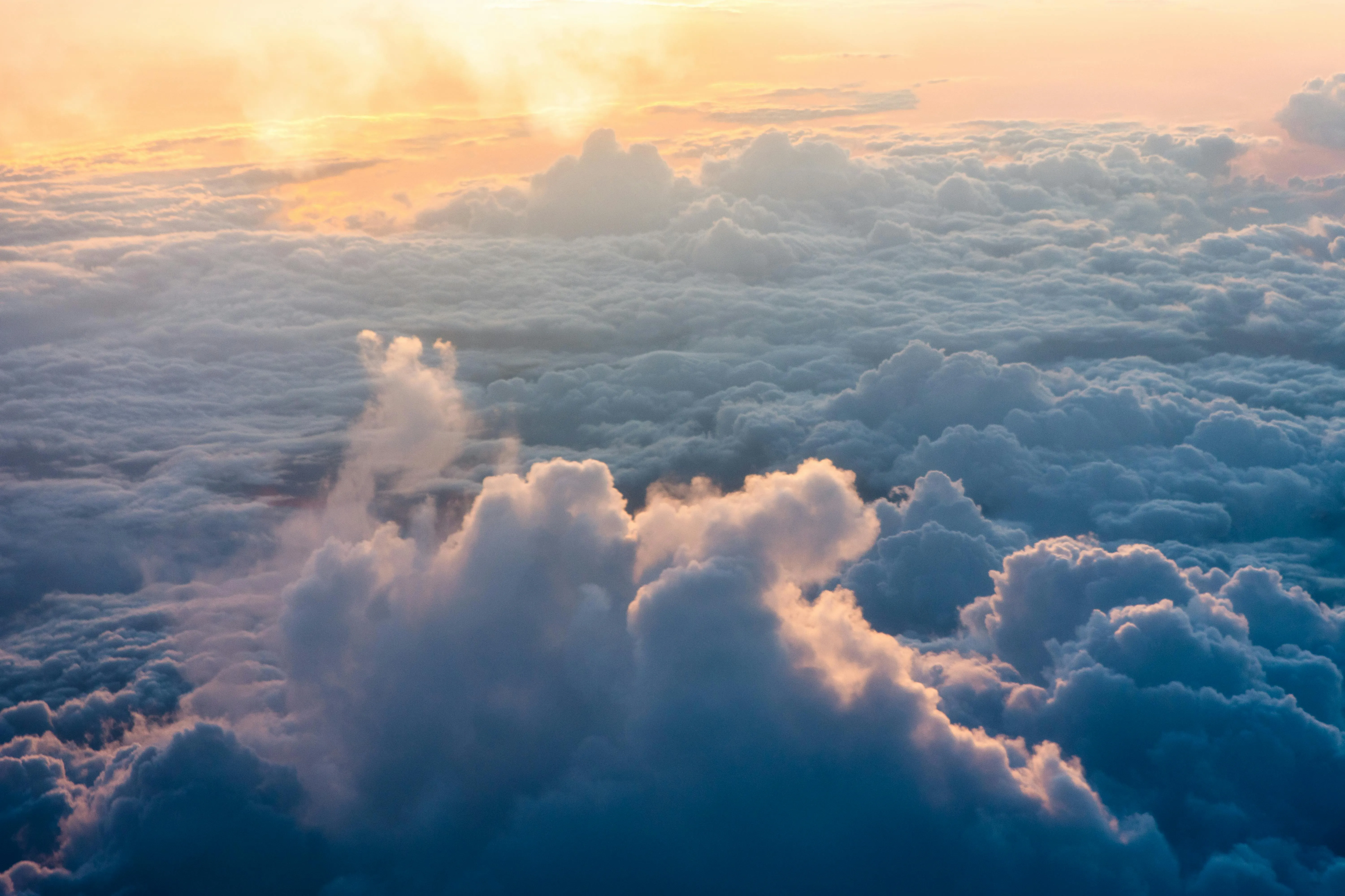 Soft Pink and Orange Light on Clouds at Sunset Image