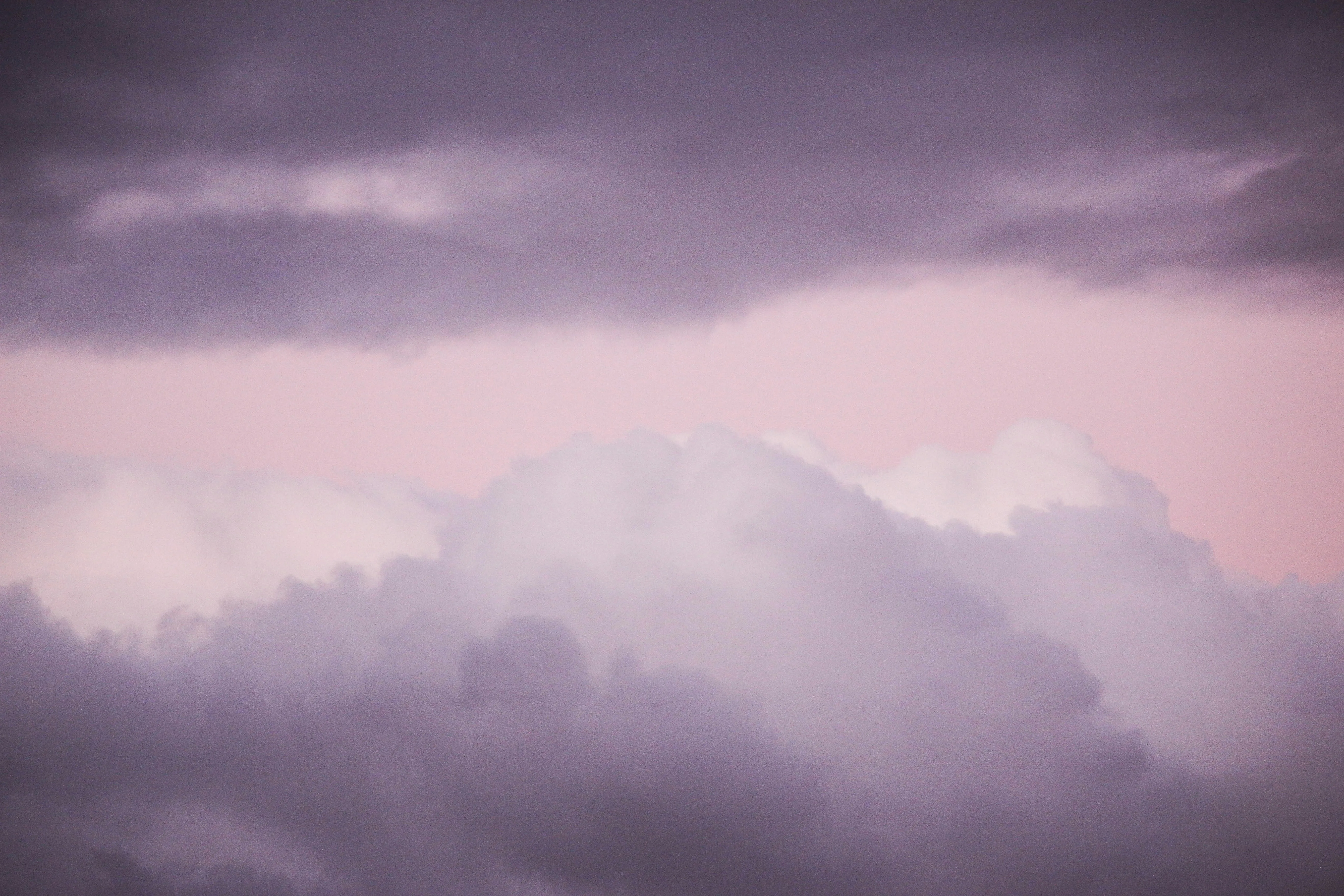 Soft Pink Clouds Hanging Low Over Mountain Landscape