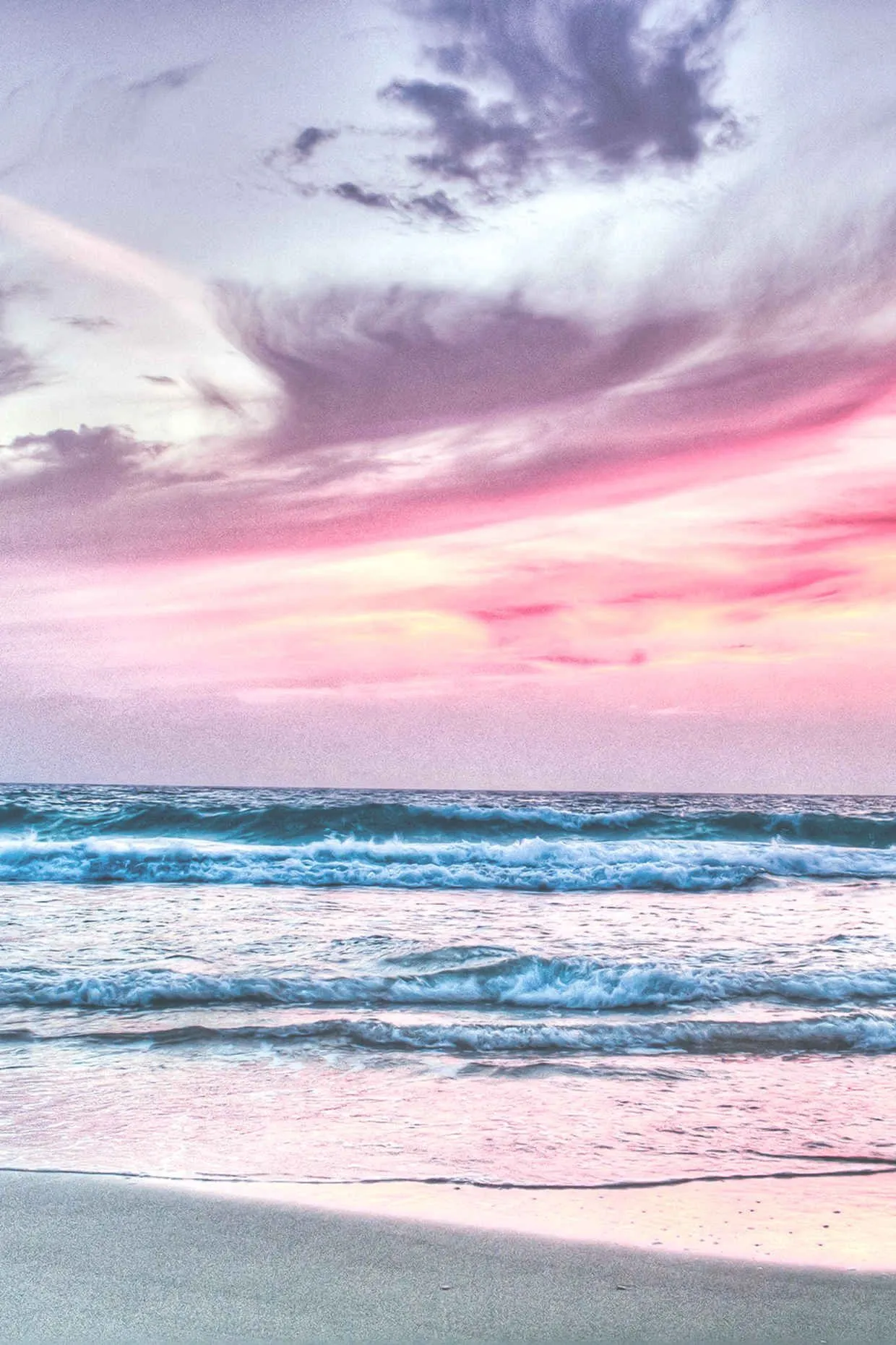 Soft Pink Sunset Over Calm Ocean and Sandy Beach Wallpaper