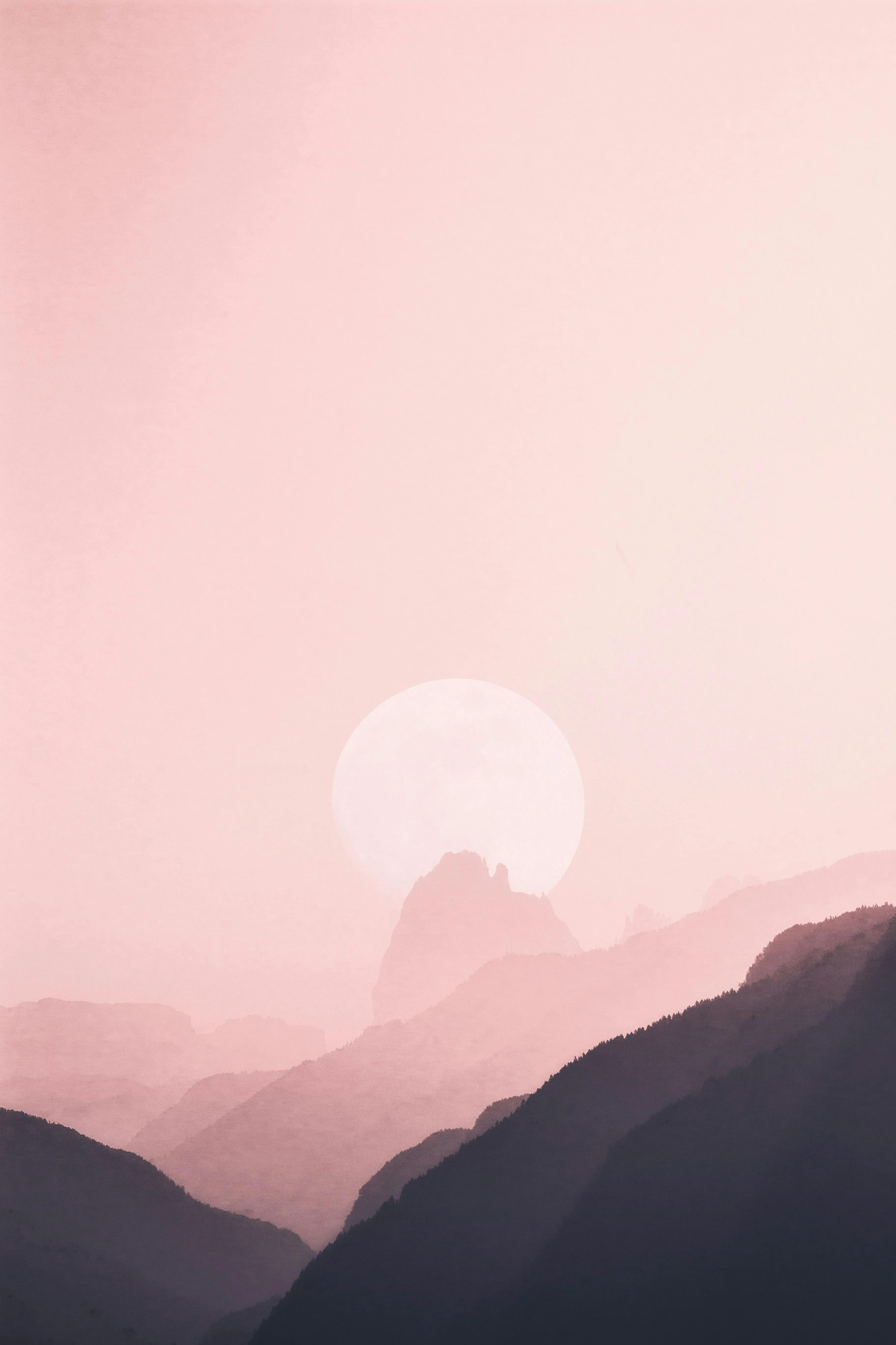 Soft Pink Sunset Sky Over Silhouetted Mountain Range