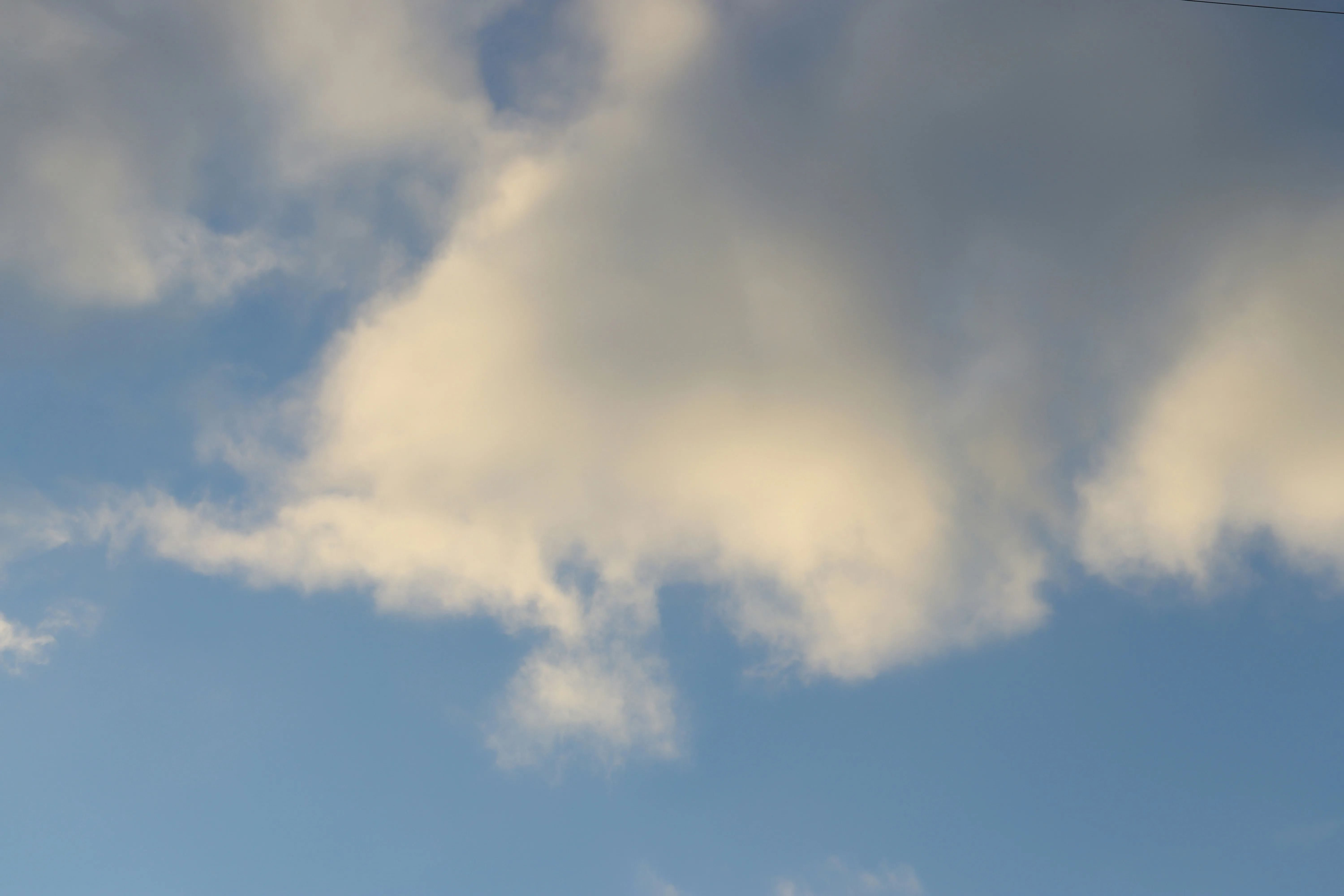 Soft White Cloud Floating in Clear Light Blue Sky Image
