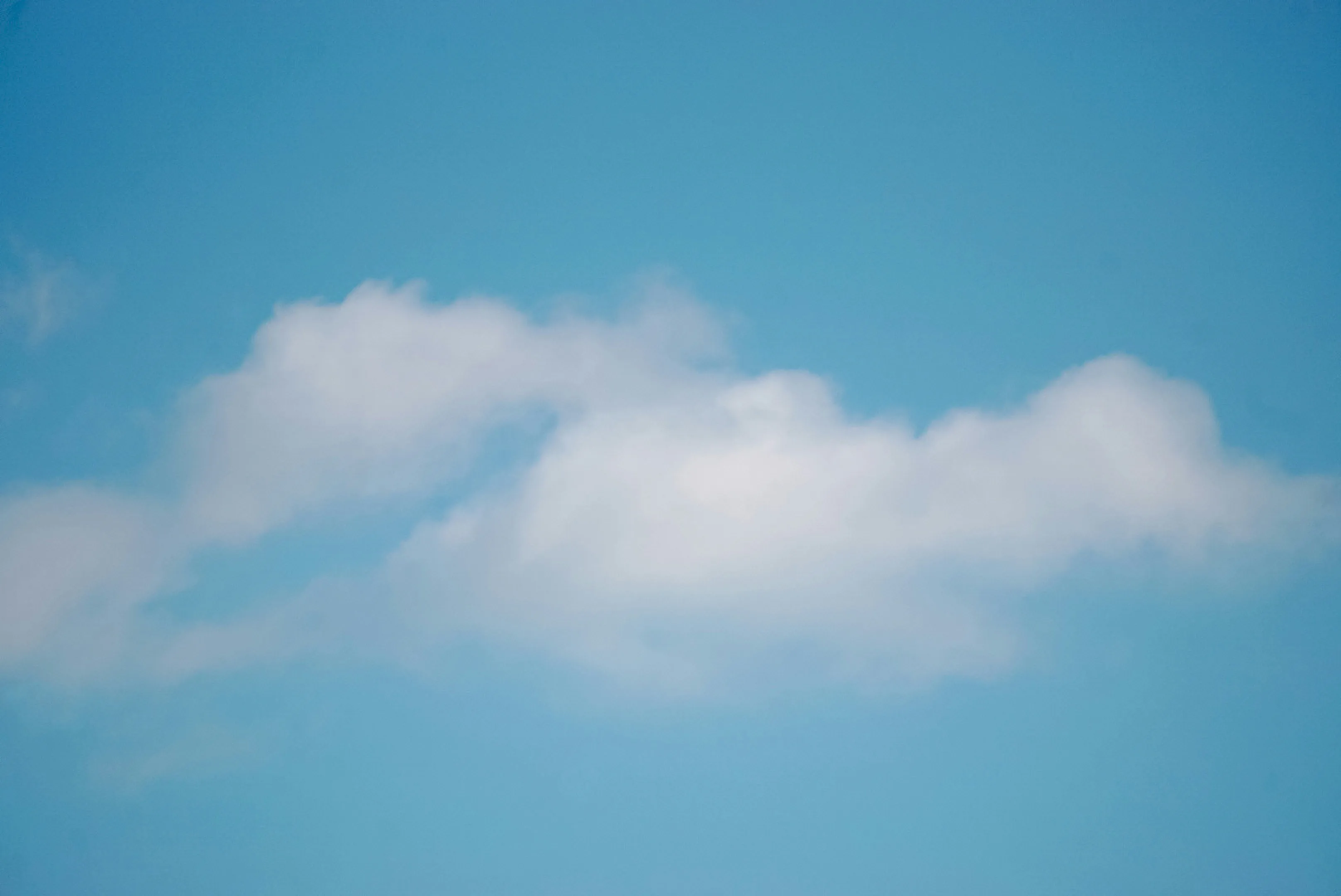 Soft White Clouds Floating in Clear Blue Sky Wallpaper