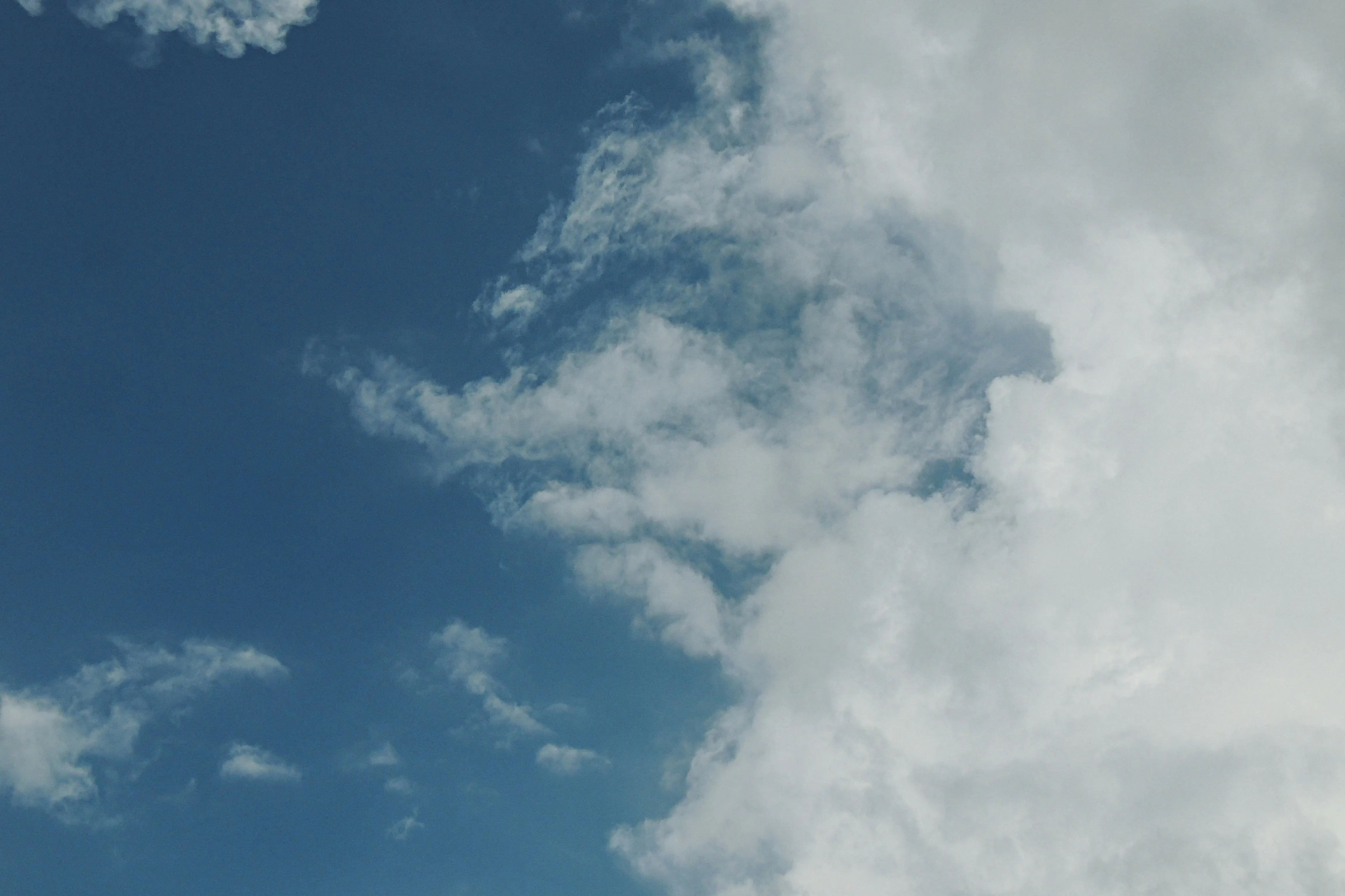 Soft White Clouds Scattered Across a Pale Sky HD Image