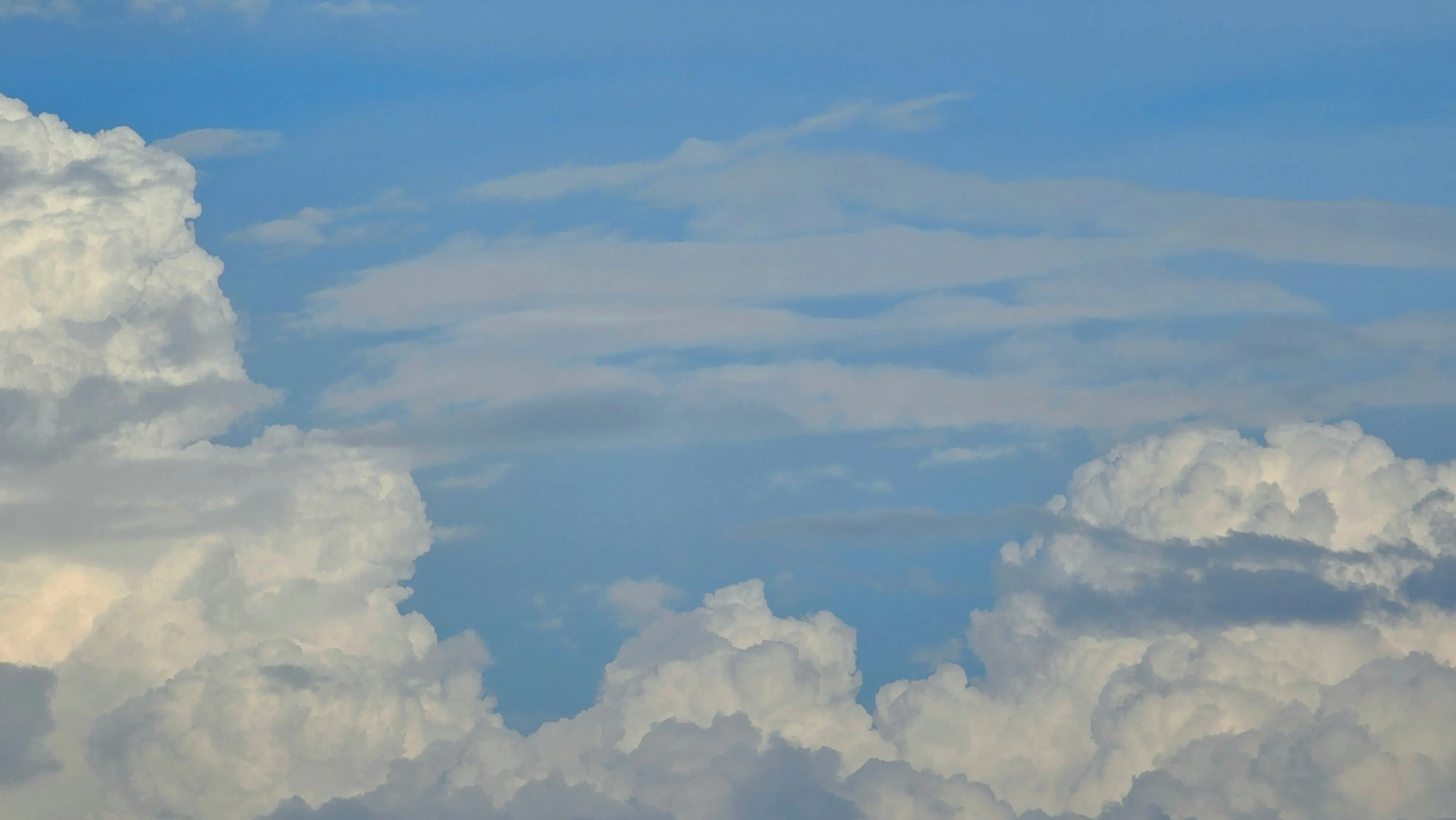Soft White Clouds Spreading Across the Blue Sky Wallpaper