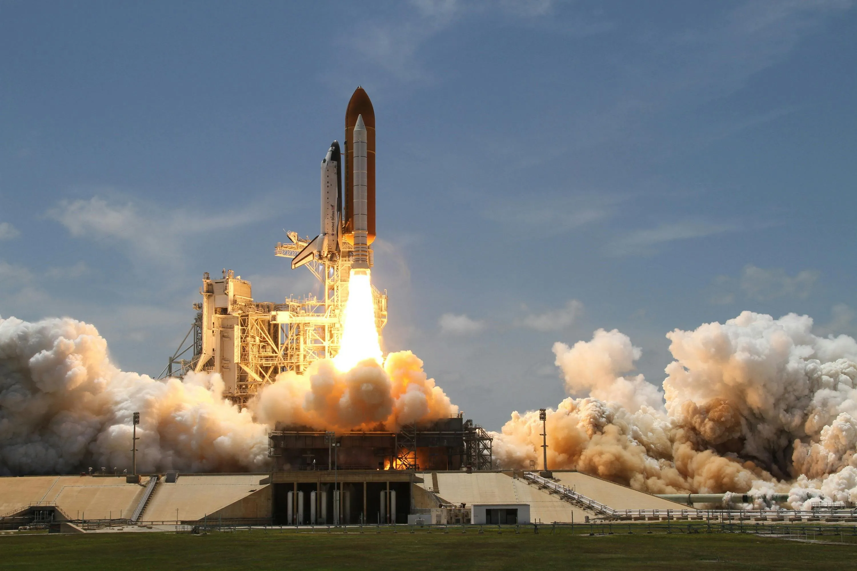 Space Shuttle Launch with Billowing White Clouds Wallpaper