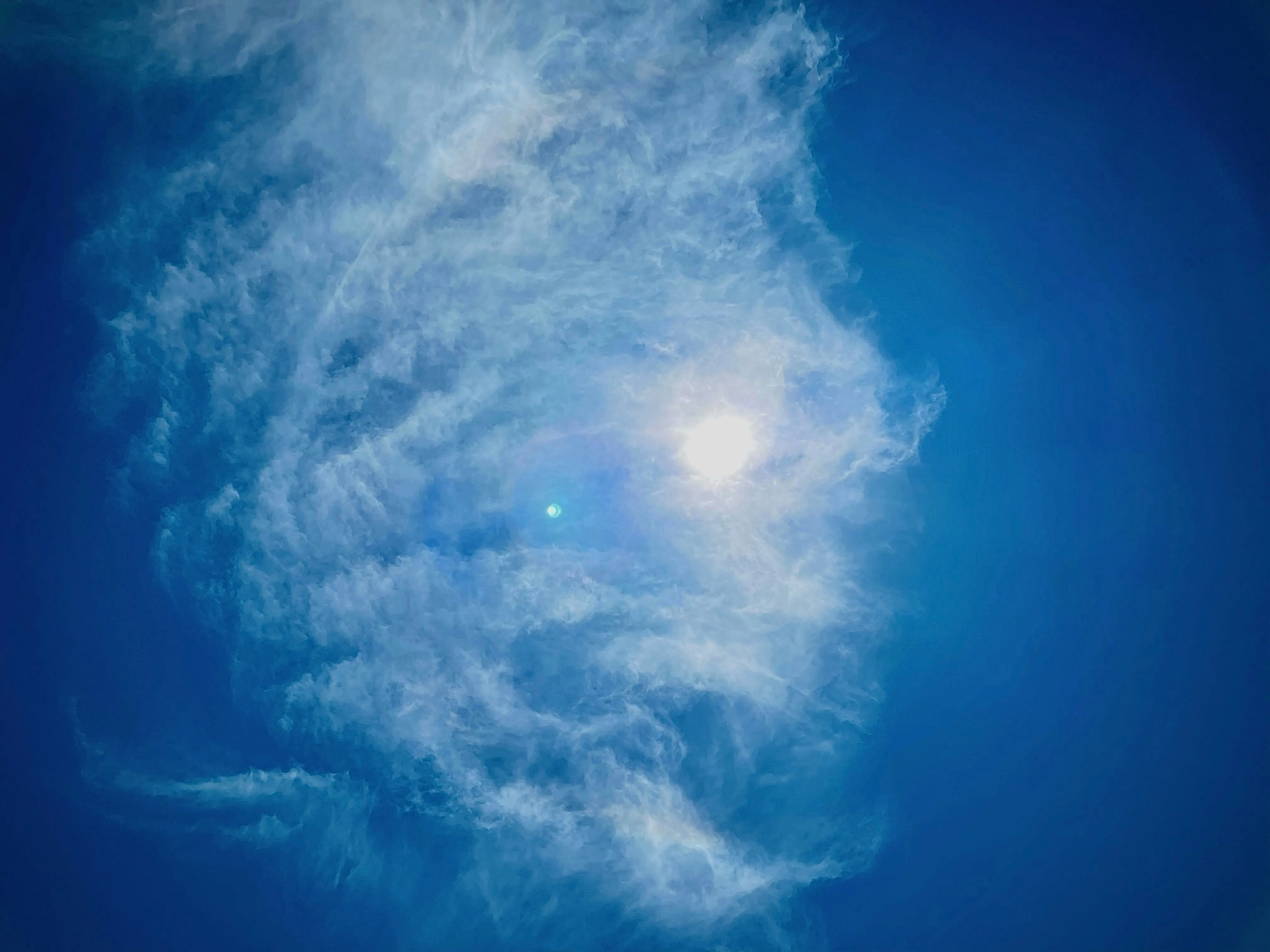 Spiral Formation of Clouds in Vivid Blue Midday Sky