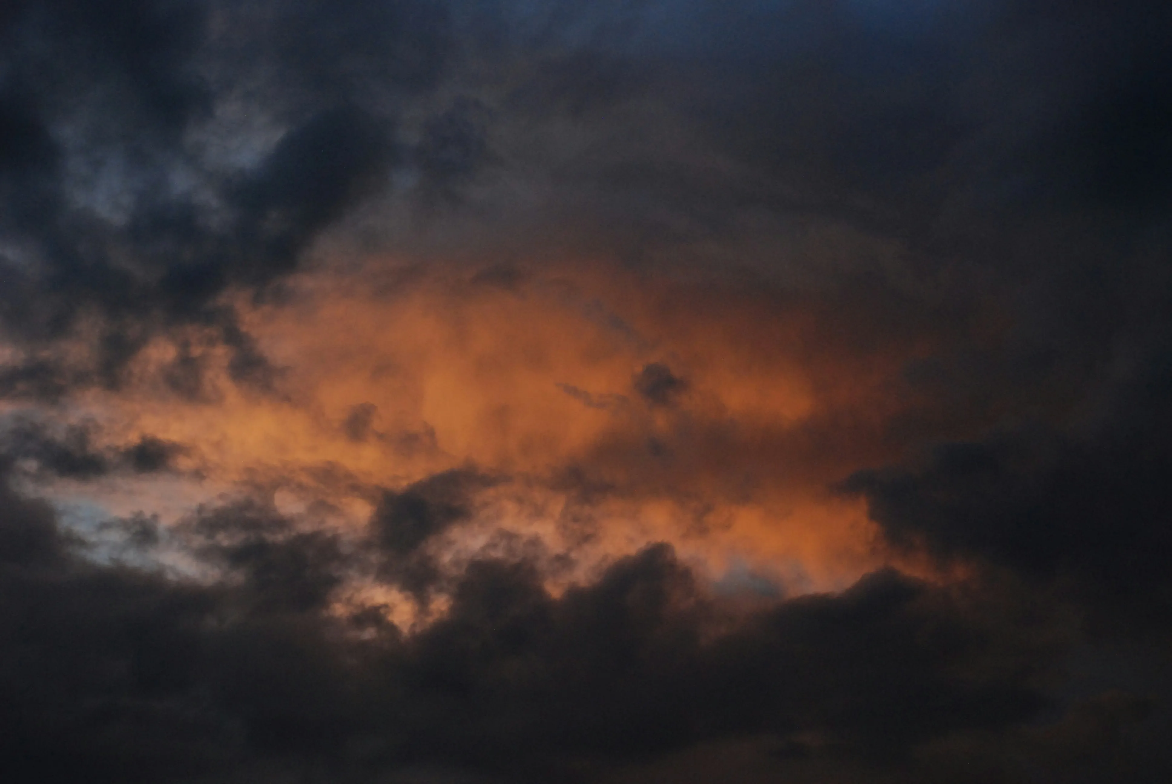 Stormy Sky with Dark Clouds Glowing From Sunset Light