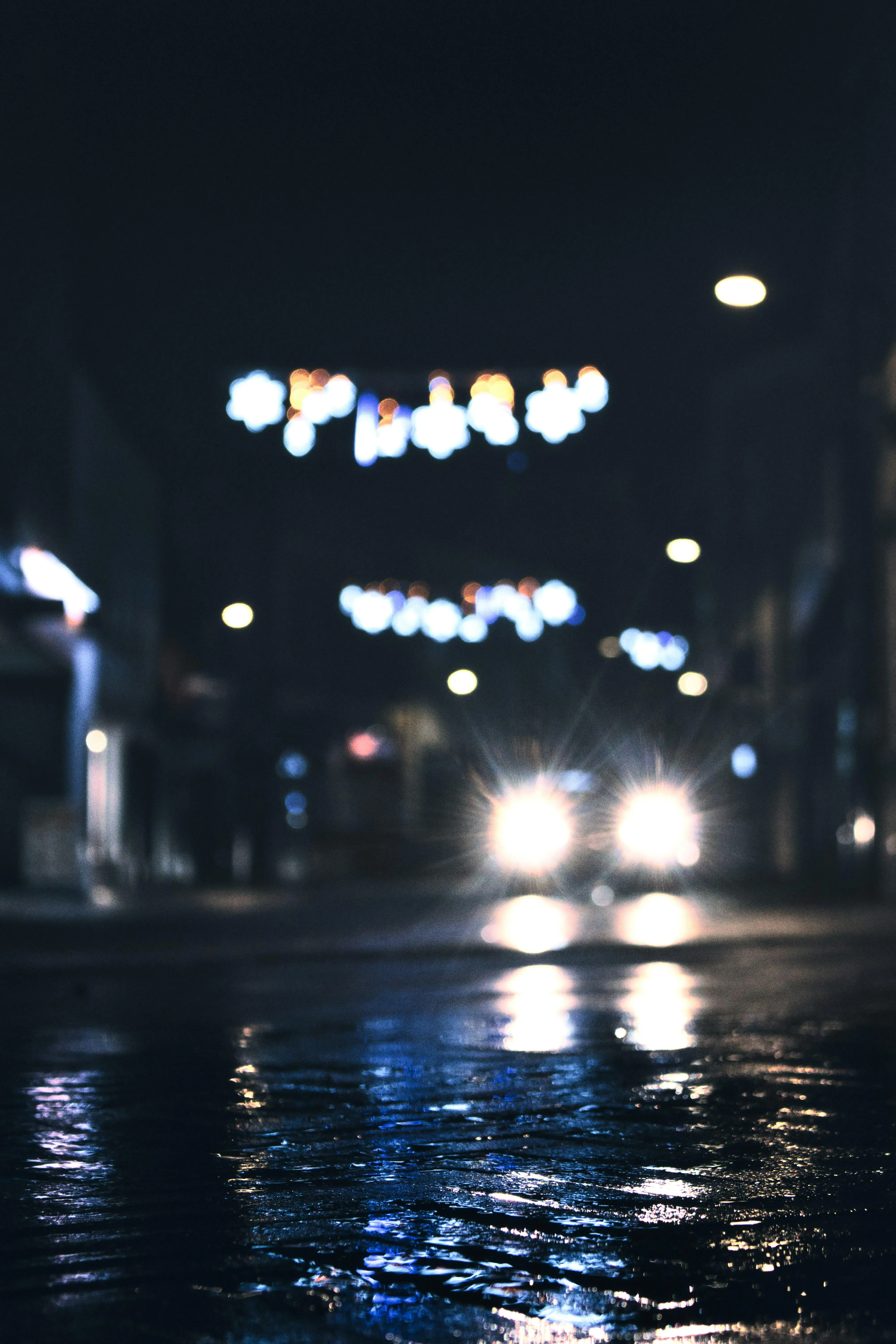 Streetlights Reflected on Wet Road During Rain Wallpaper