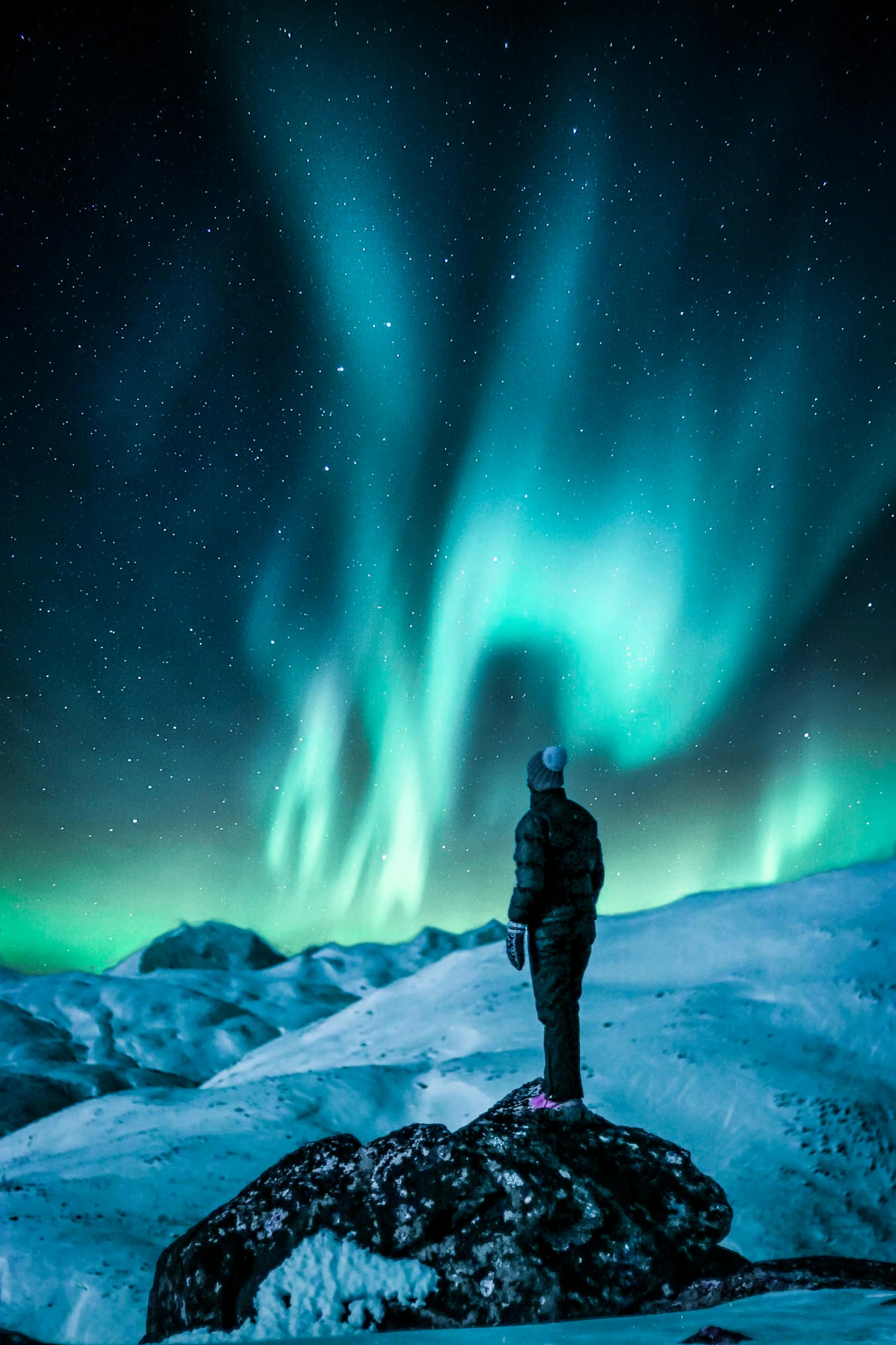Stunning Northern Lights Display Over Snowy Mountain Landscape