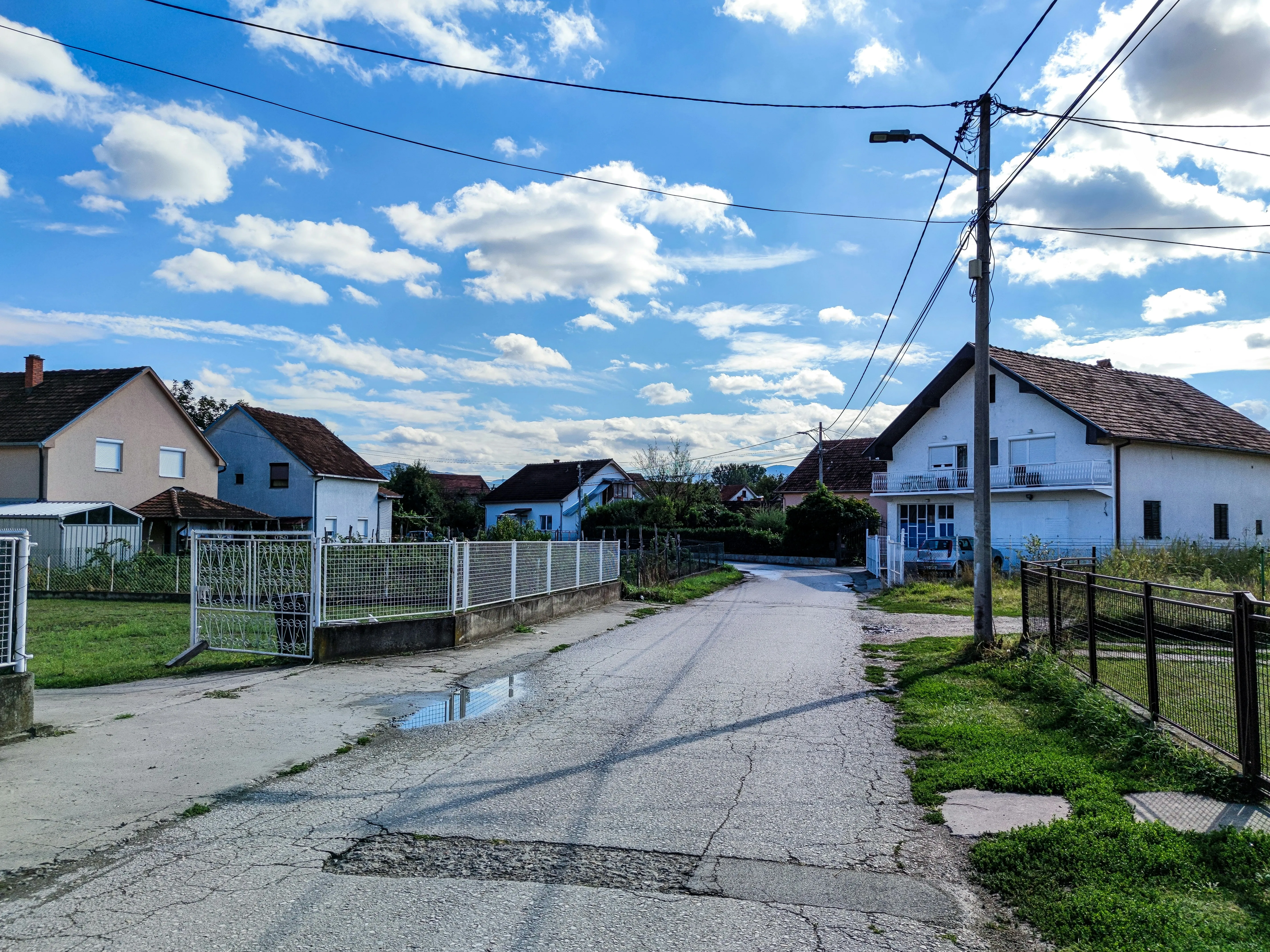 Suburban Neighborhood with Bright Midday Clouds and Sky