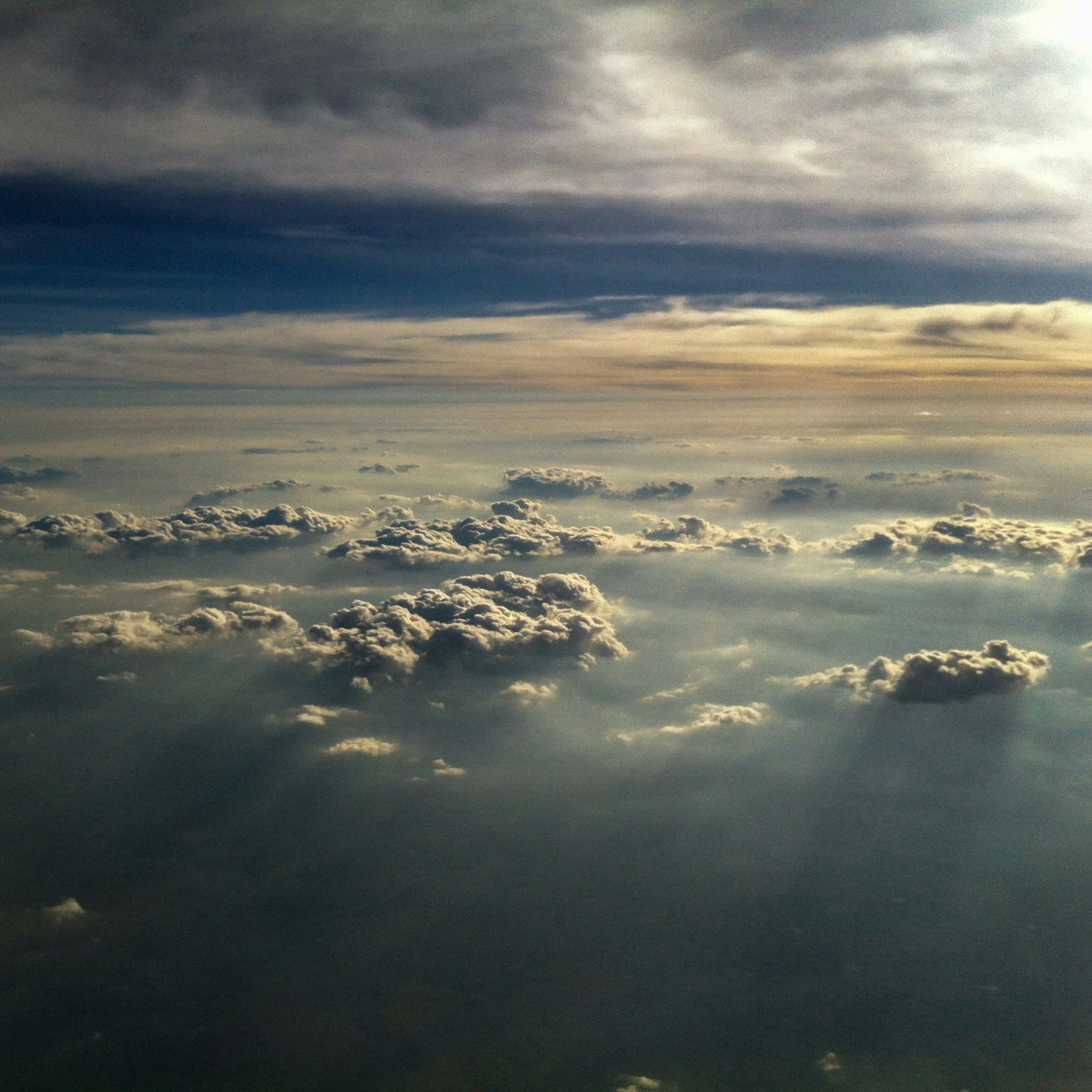 Sun Rays Breaking Through Clouds Over Ocean at Sunset