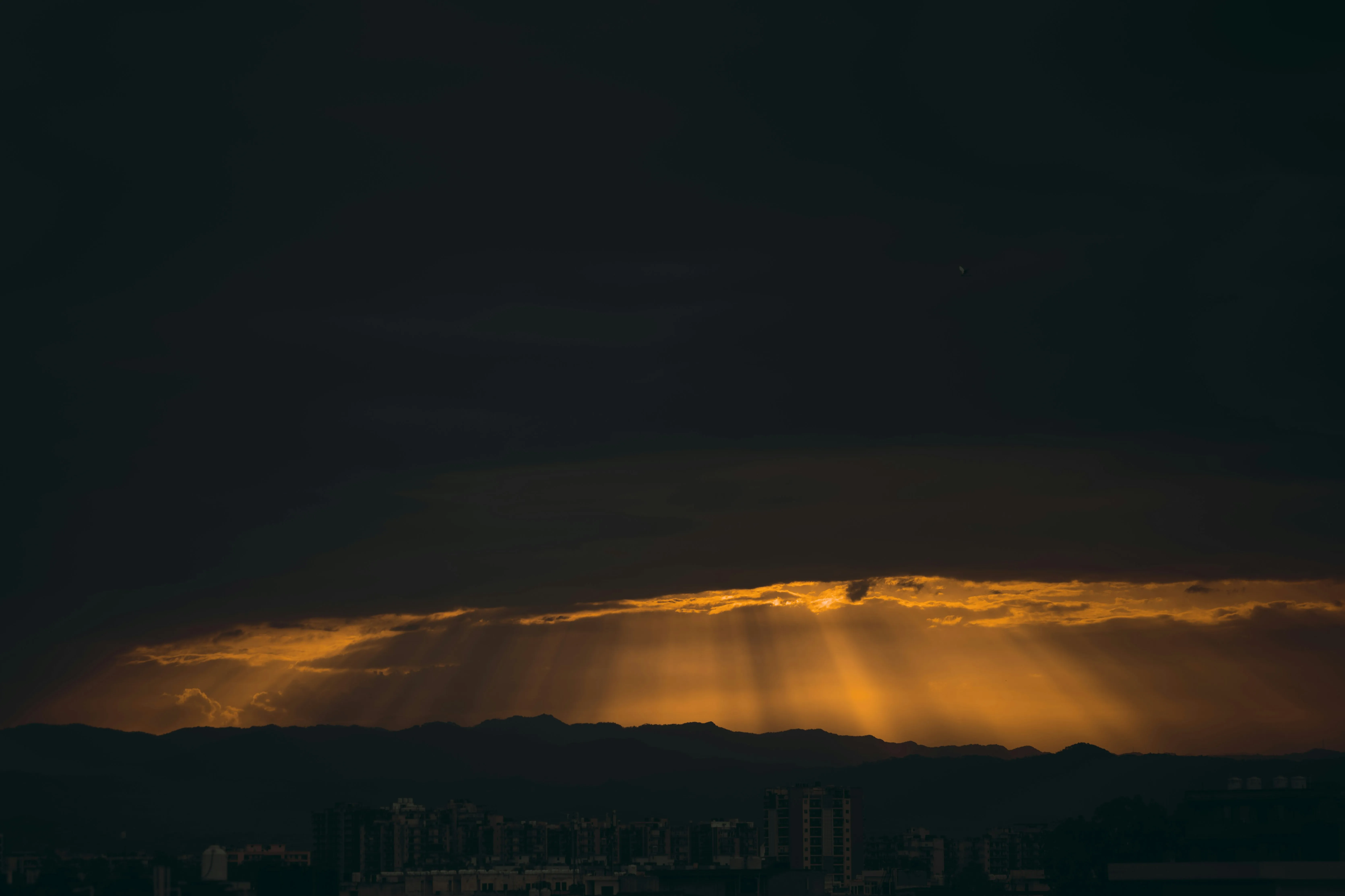 Sun Rays Breaking Through Dark Clouds Creating a Golden Glow