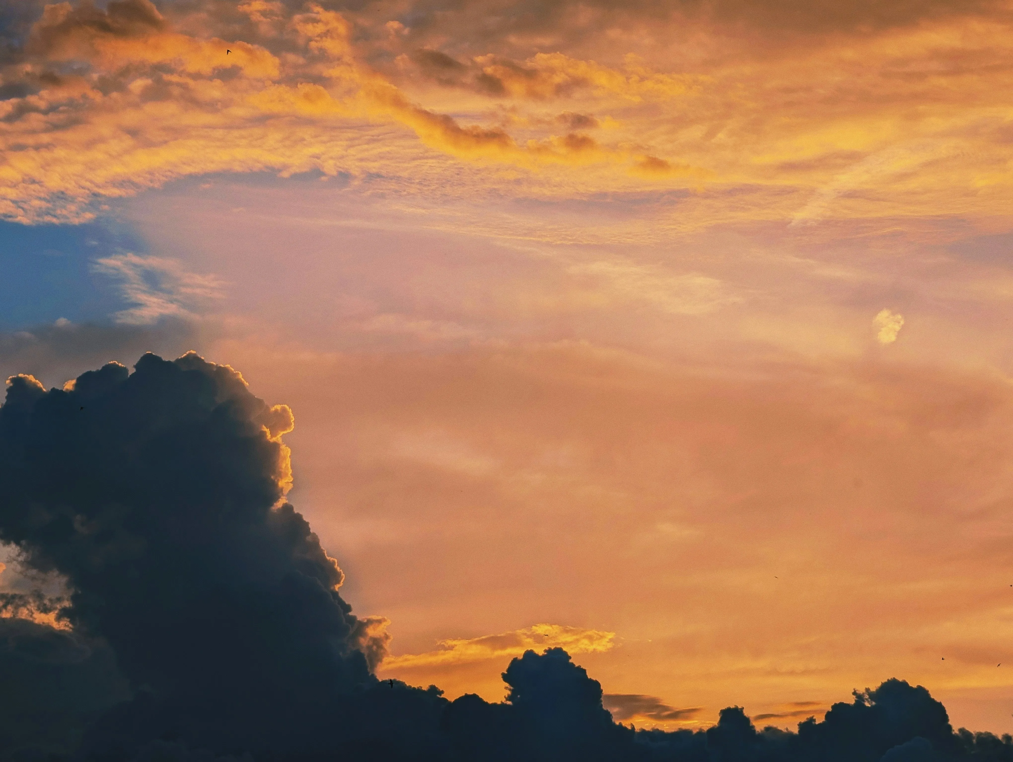 Sun Rays Shining Behind Massive Cloud at Sunset Image