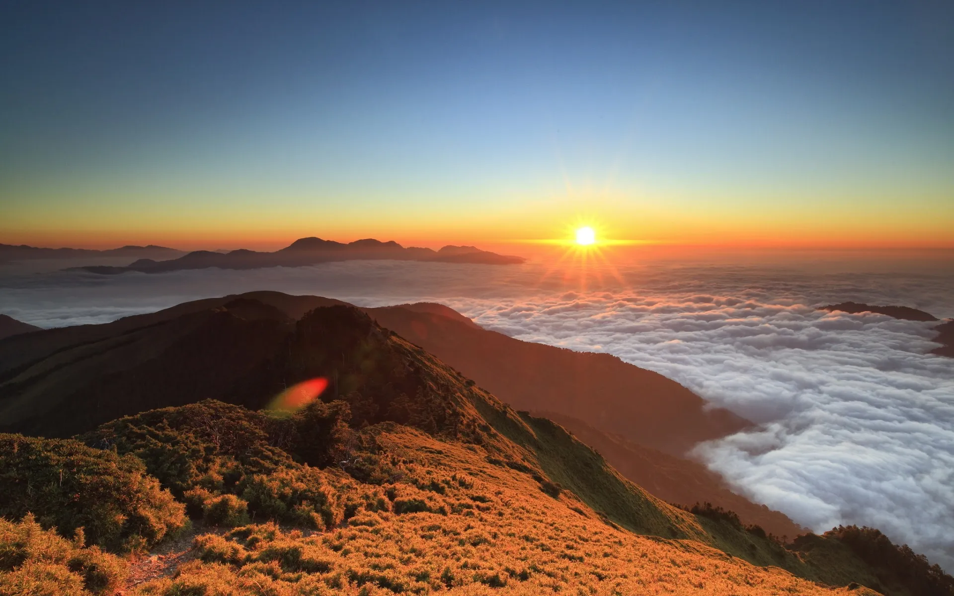 Sun Setting Over Clouds and Hills in Golden Hour Light