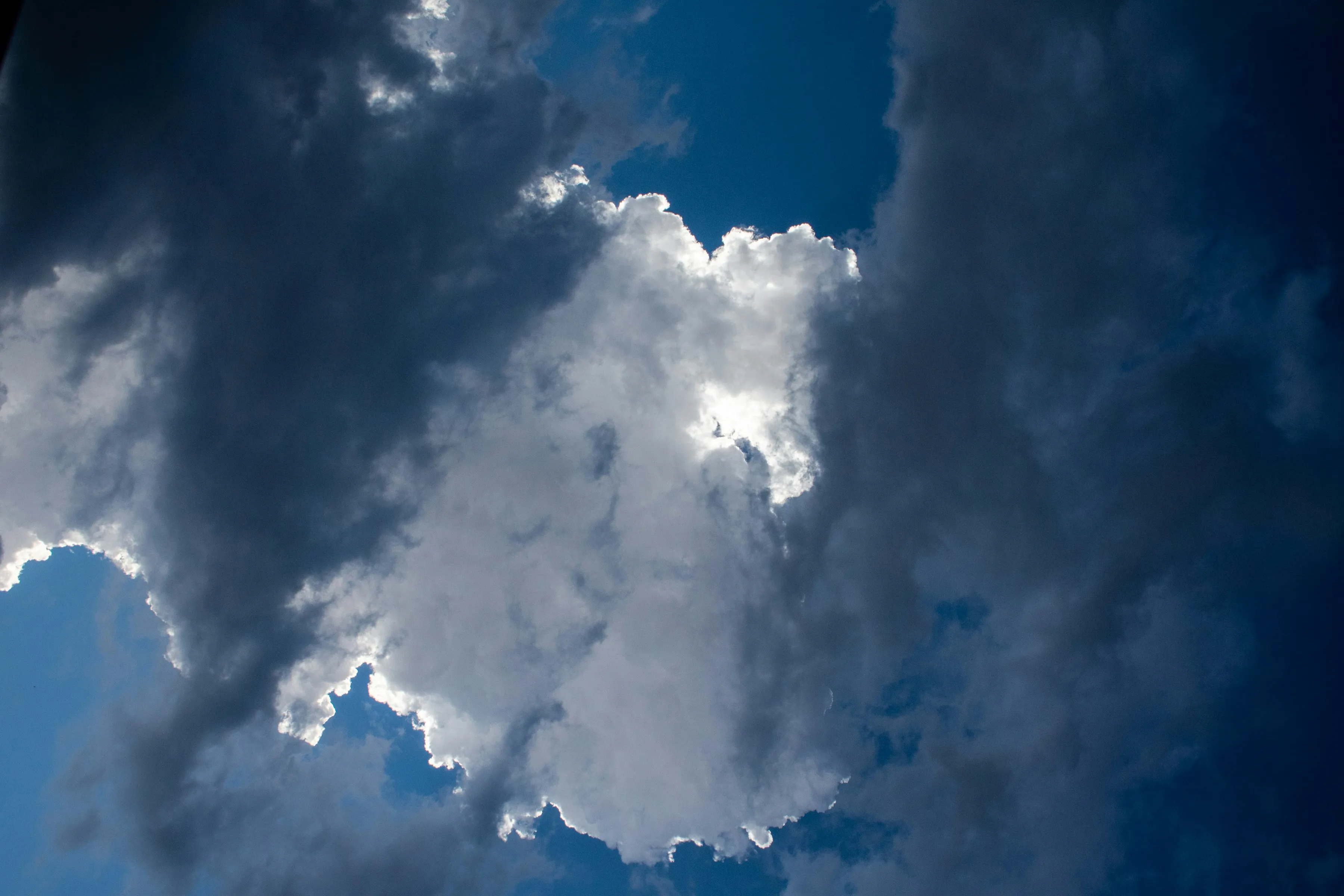 Sunlight Shining Through Large Towering Storm Clouds